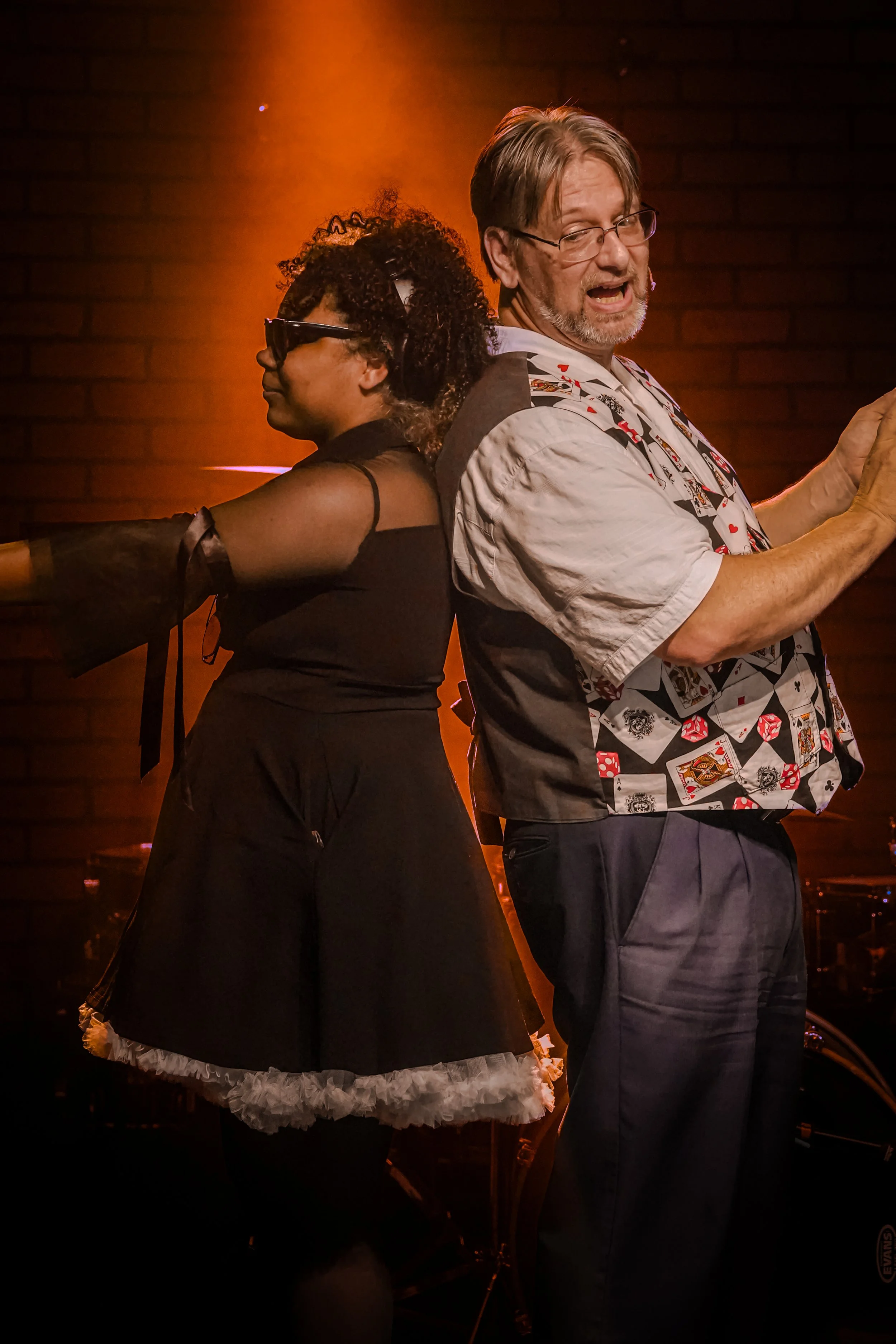 A magician conducting a magic trick with a participant from the audience.