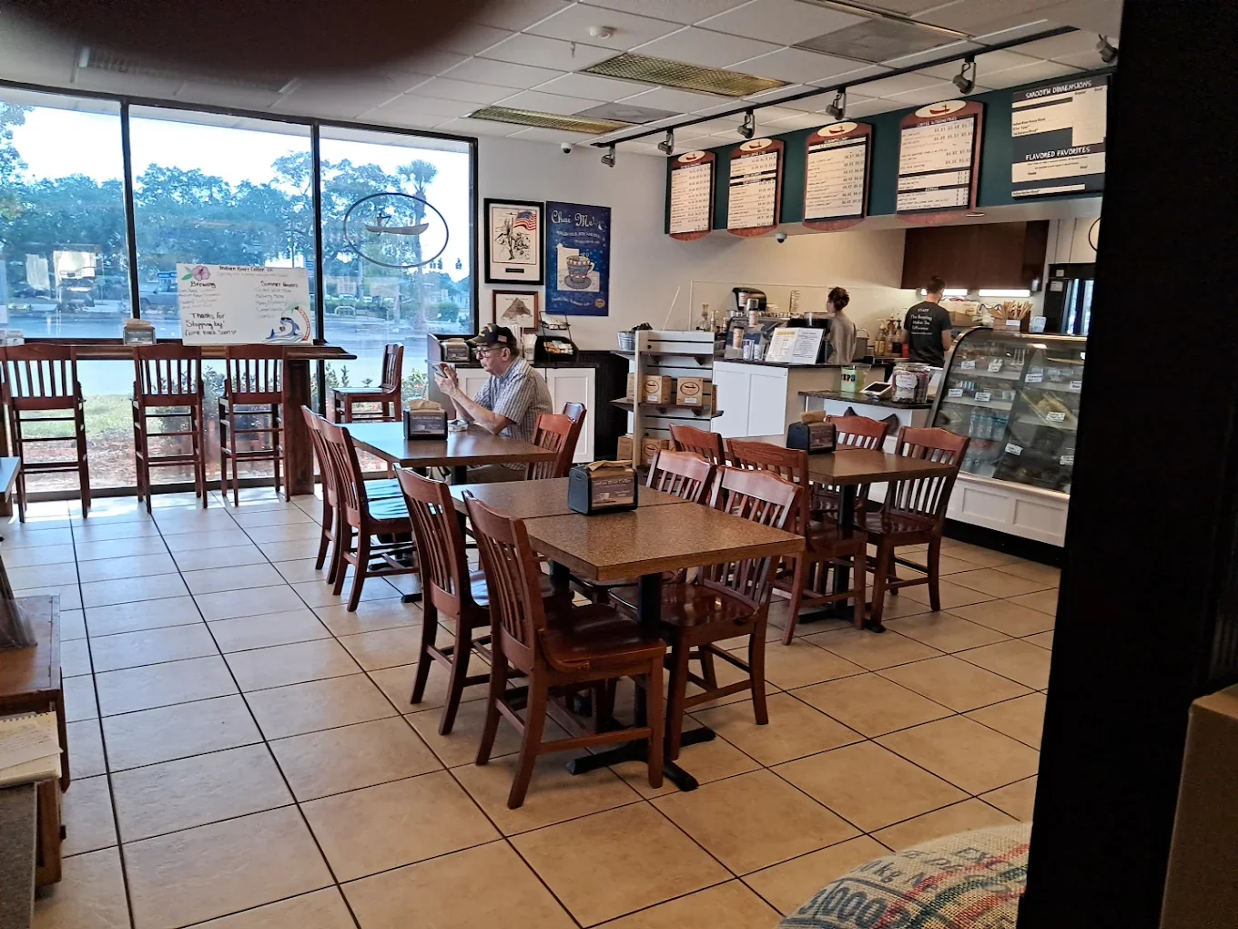 Interior of Indian River Coffee Co with low and high top tables visible