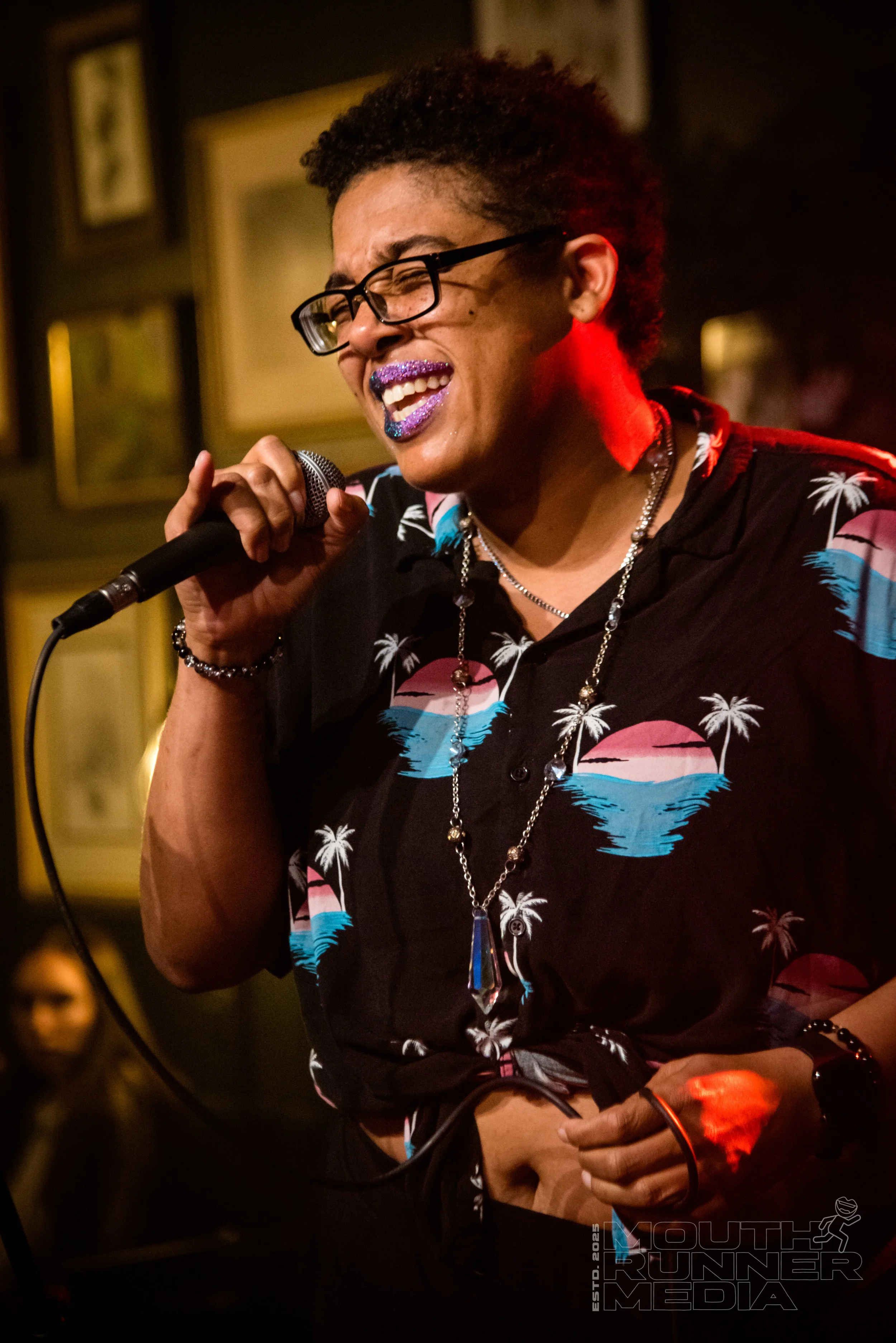 A person passionately singing into a microphone