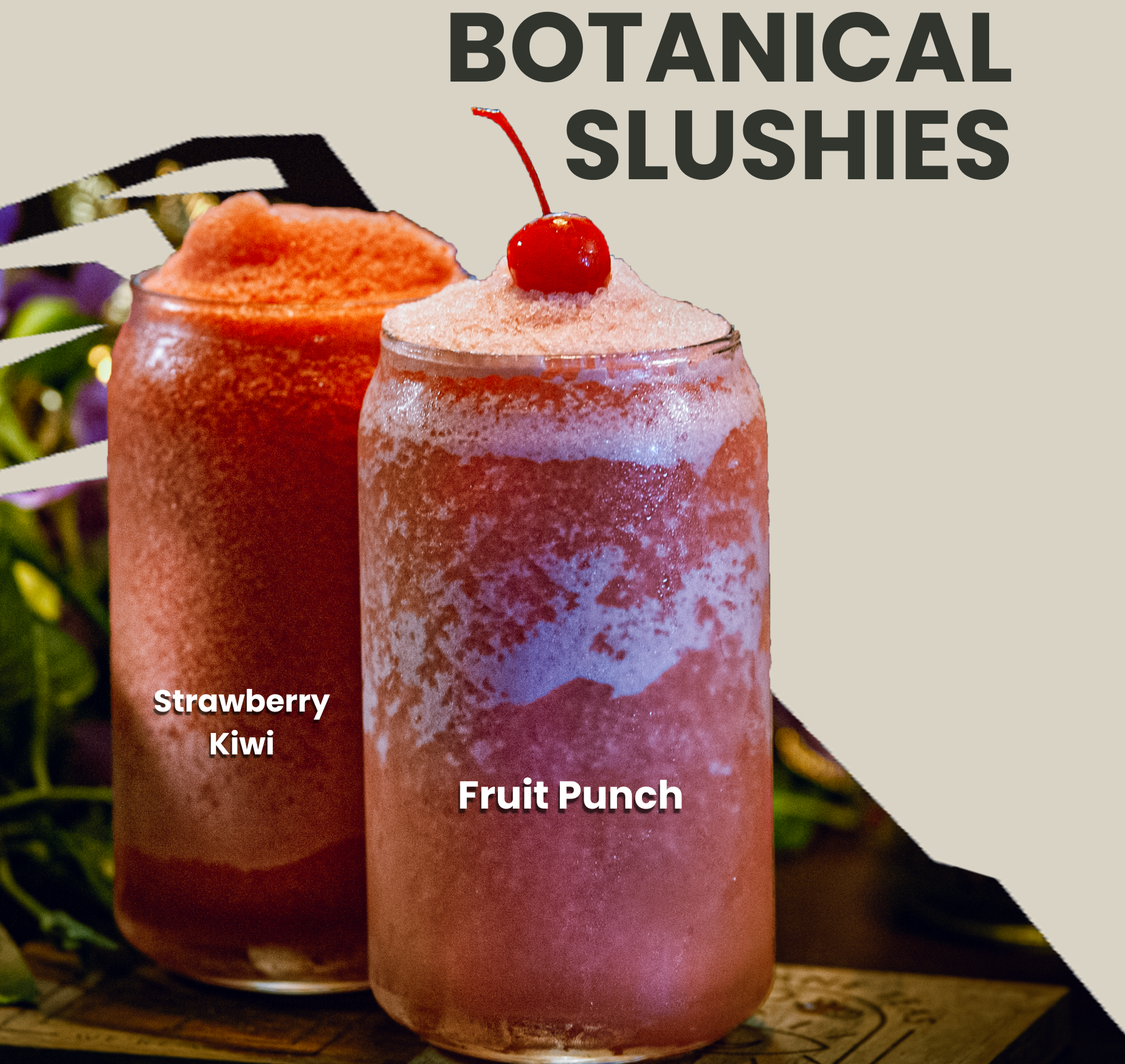 Two cups containing slushy sitting on a coaster. The cup on the right has a maraschino cherry on top. There is foliage in the background, and the background is cut out in the shape of a snow topped mountain