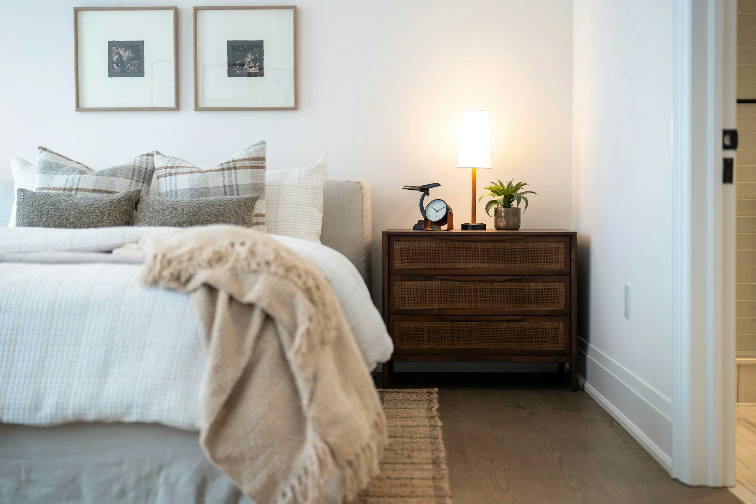 Comfortable bed with pillows and clean layered bedding in a cozy bedroom