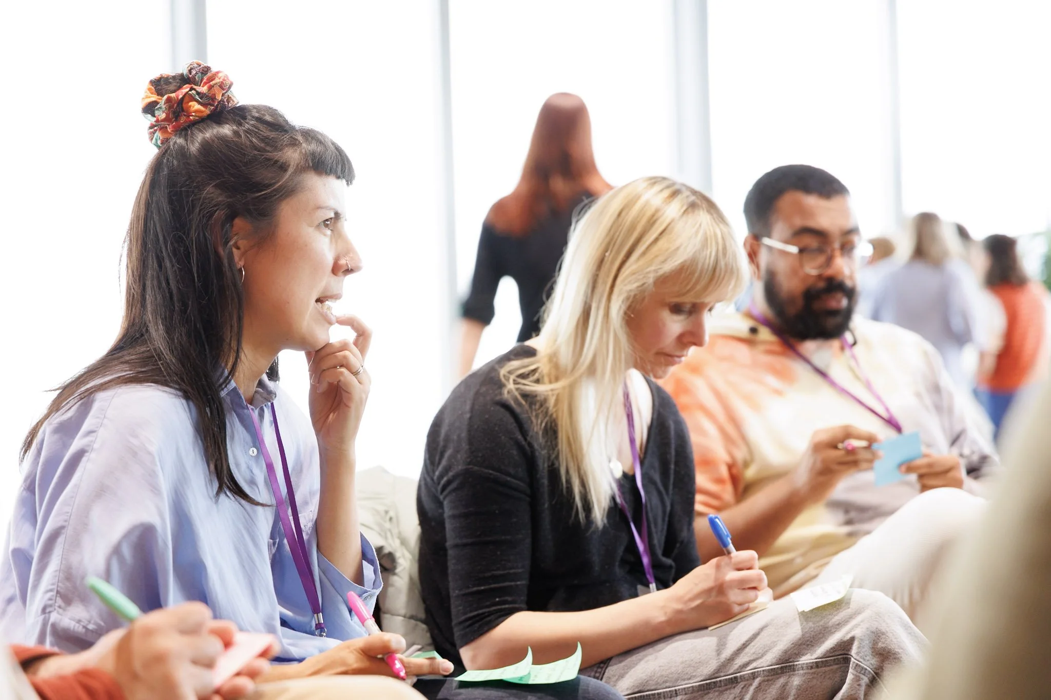 Three workshop participants facing forward, reflecting..