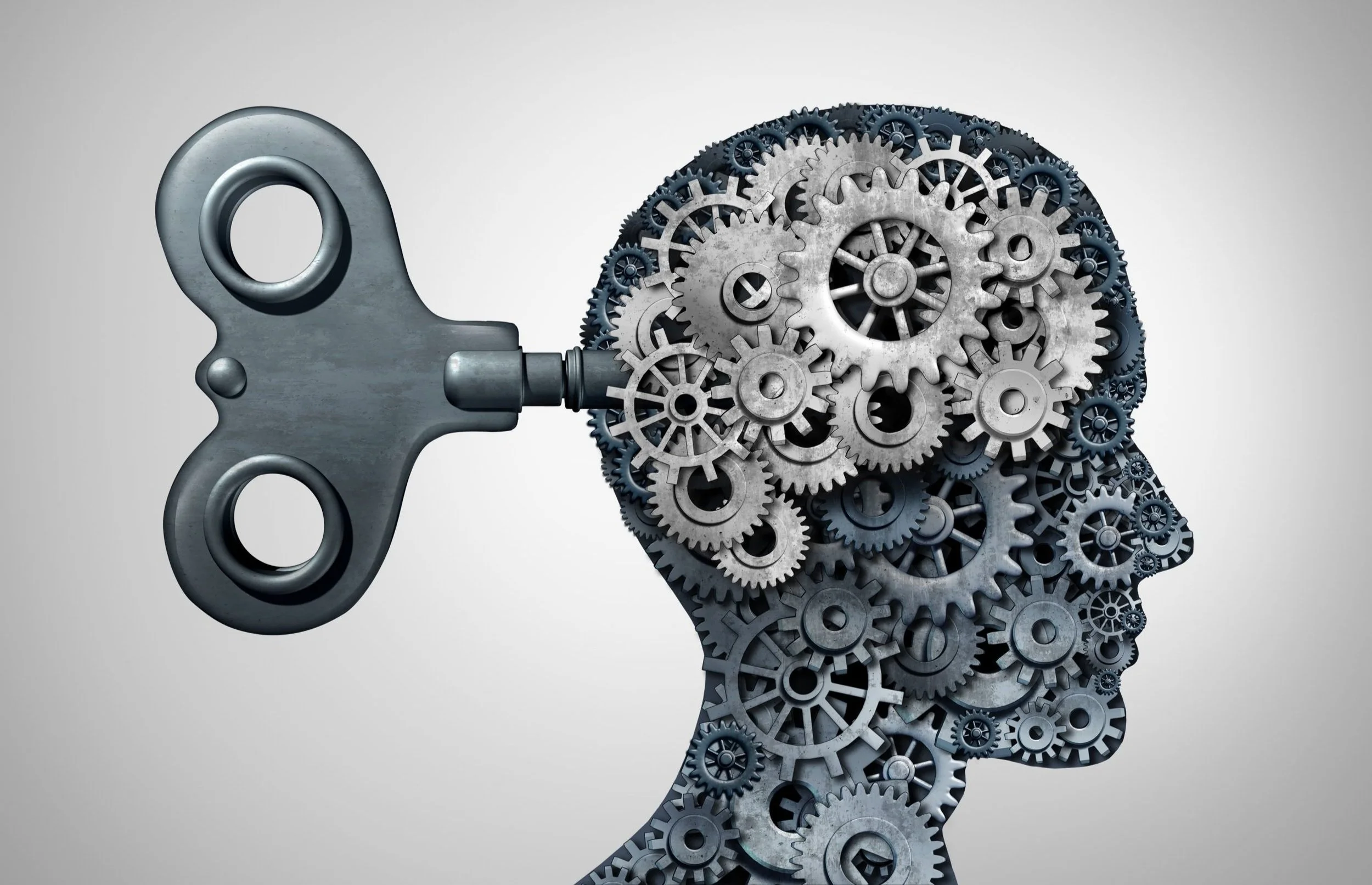 A human head silhouette made of gears with a wind-up key.