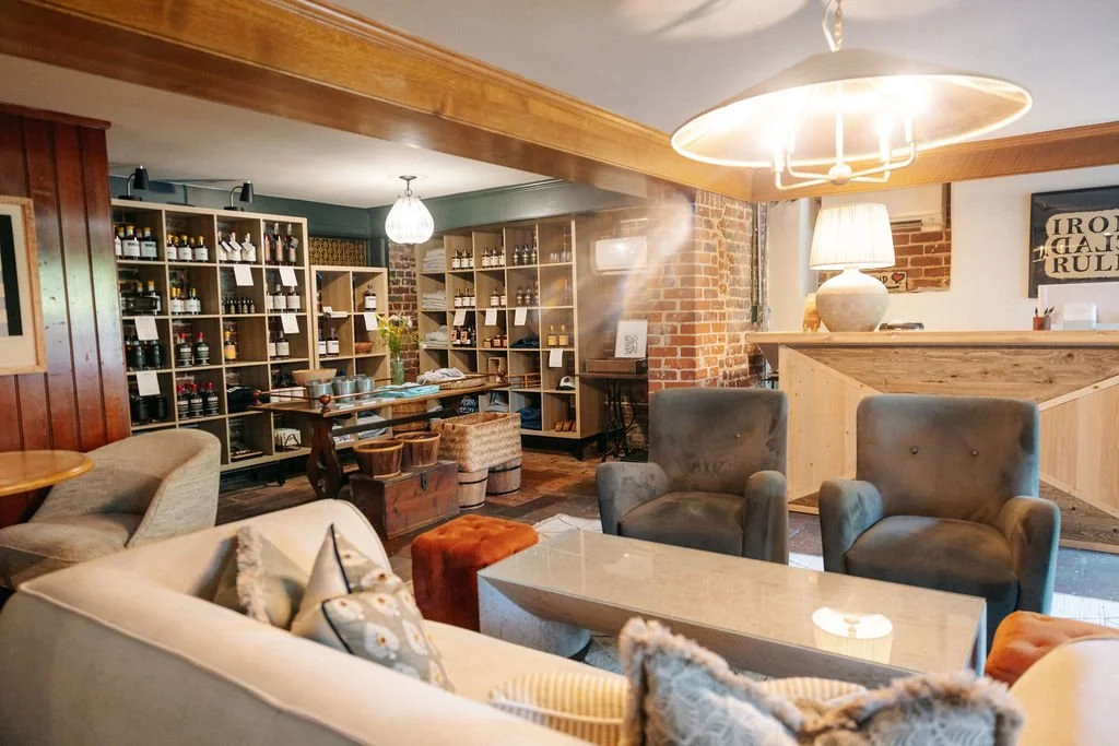 Comfortable sitting room with sofas at Stable Block Bourbon Room Fredericksburg bourbon tasting