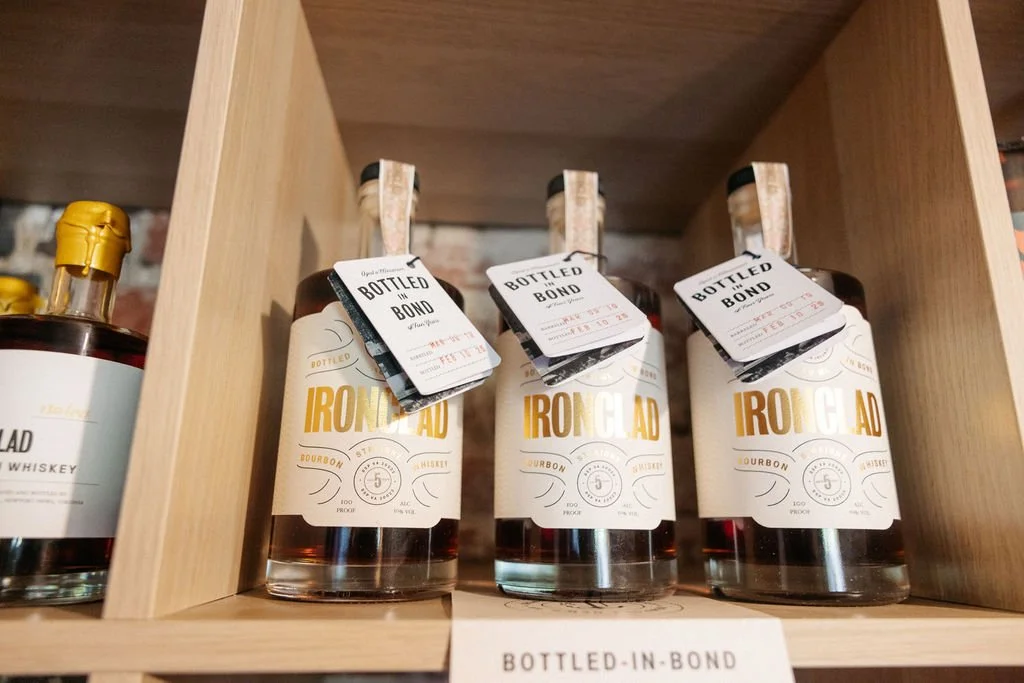 Bottles of house label bourbon for sale at Stable Block Bourbon Room Fredericksburg bourbon tasting room