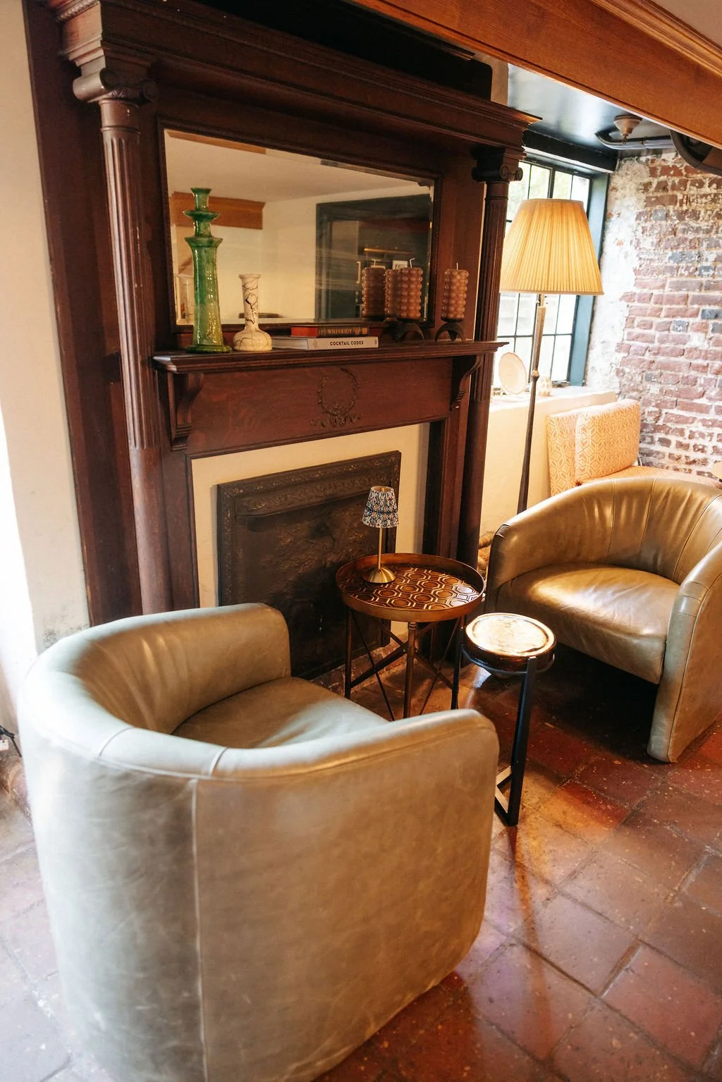Fireplace detail of the bourbon lounge seating area at Ironclad Inn Fredericksburg Virginia whiskey bar