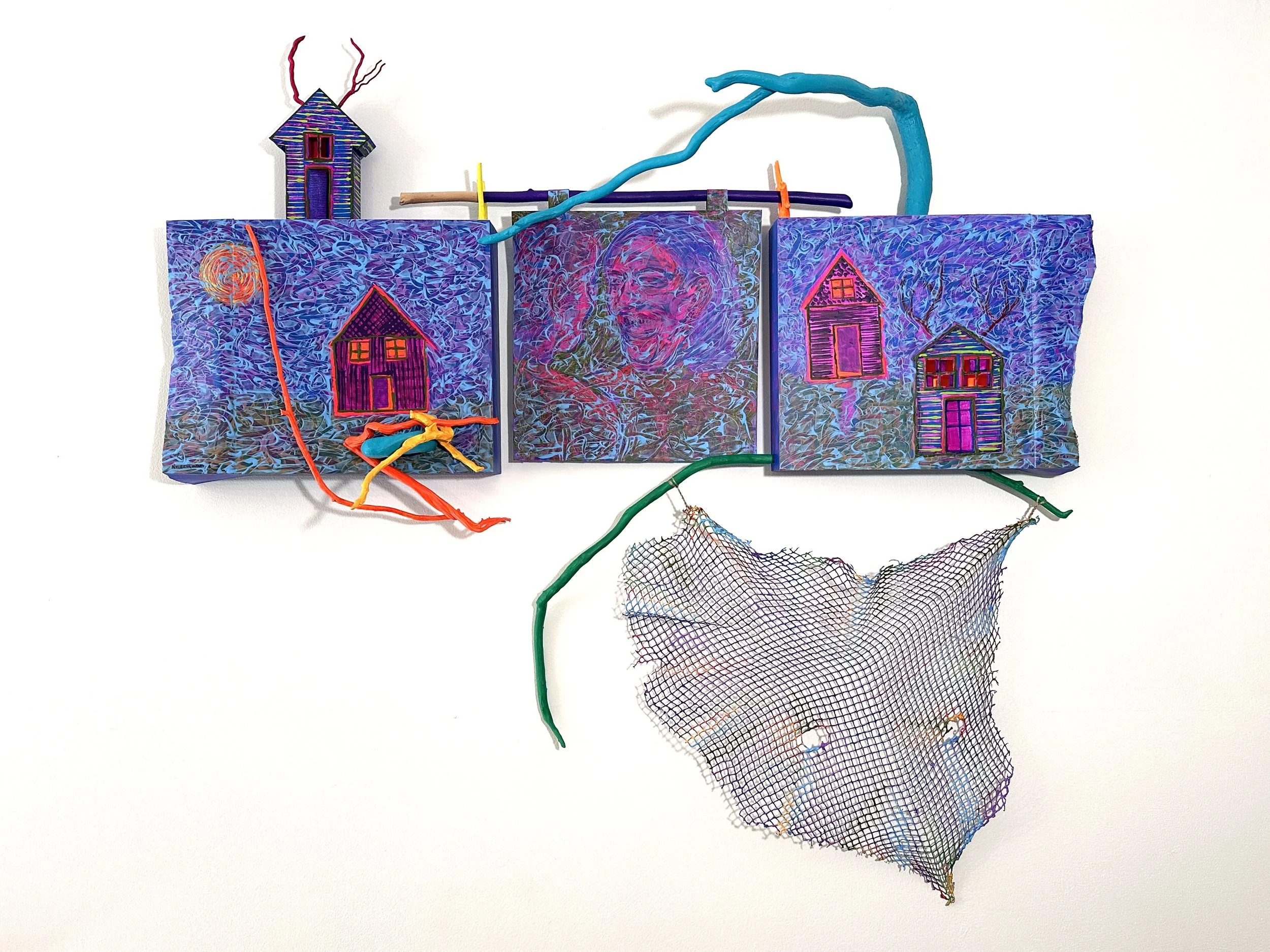 Anima Mundi abstract mixed media art piece with three painted panels, a house and tree designs, a small with red antlers, colorful branches and a net on a white background exploring paradoxical themes of gender, power, and safety.