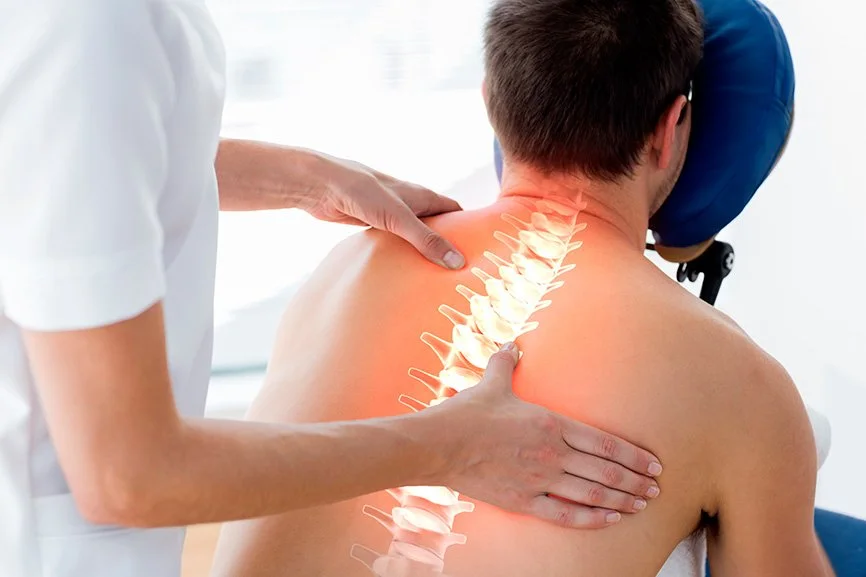 Doctor examining a patient with an illustration of a spine overlaid on the patient's back.
