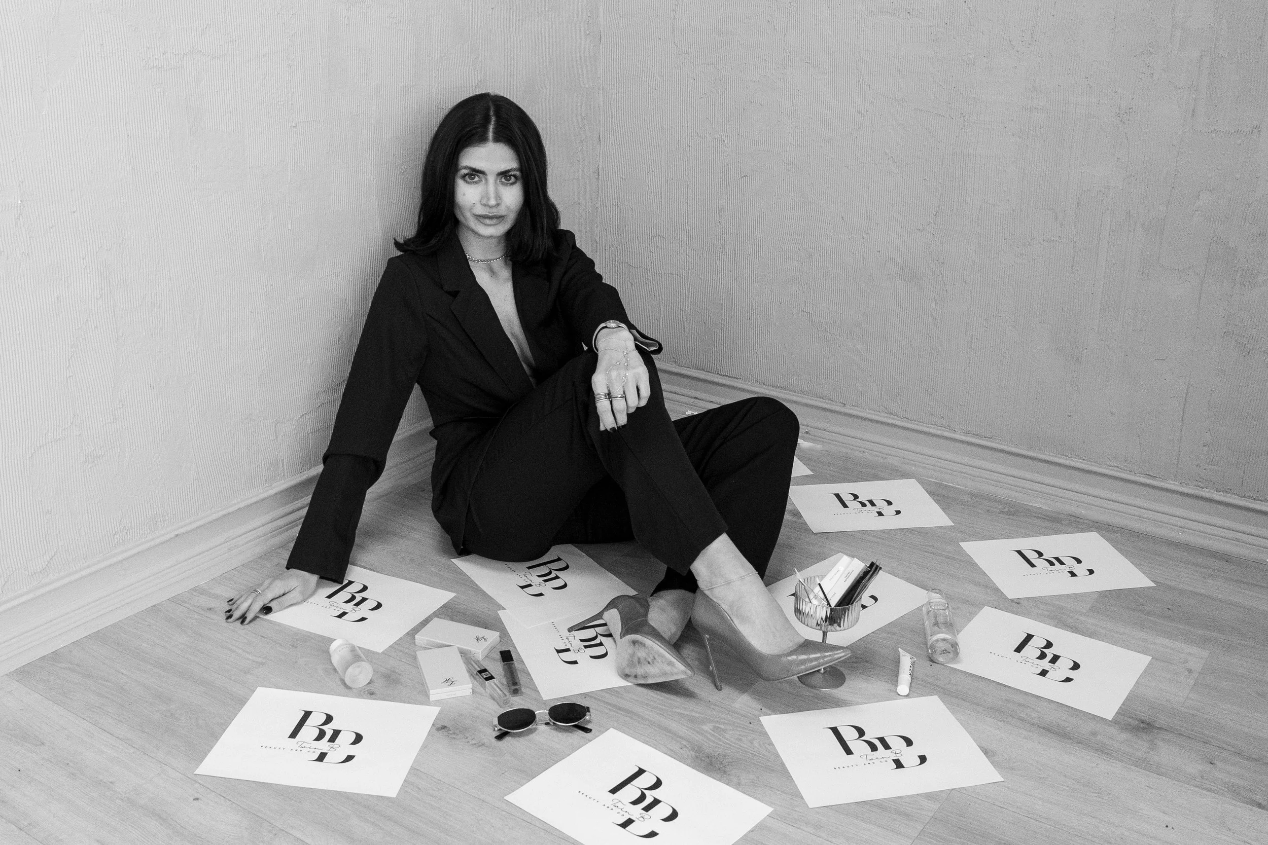 Beauty brand lifestyle scene featuring a licensed esthetician surrounded by skincare, beauty products, and tools, representing personalized skincare services, professional treatments, and curated retail products available at Twin B Beauty Co.