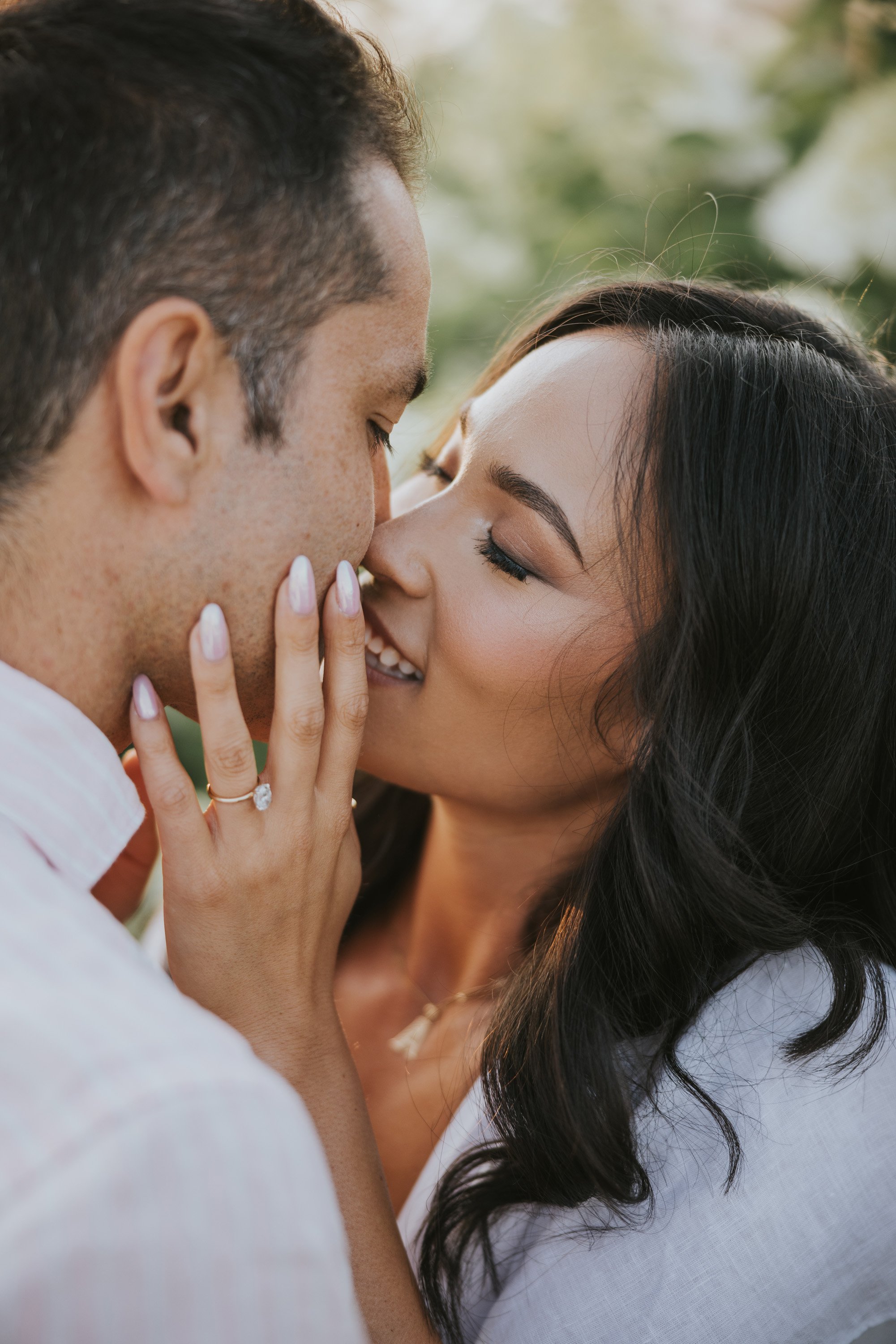 Closeup of a couple sharing an intimate kiss, highlighting their connection and love during their engagement session.