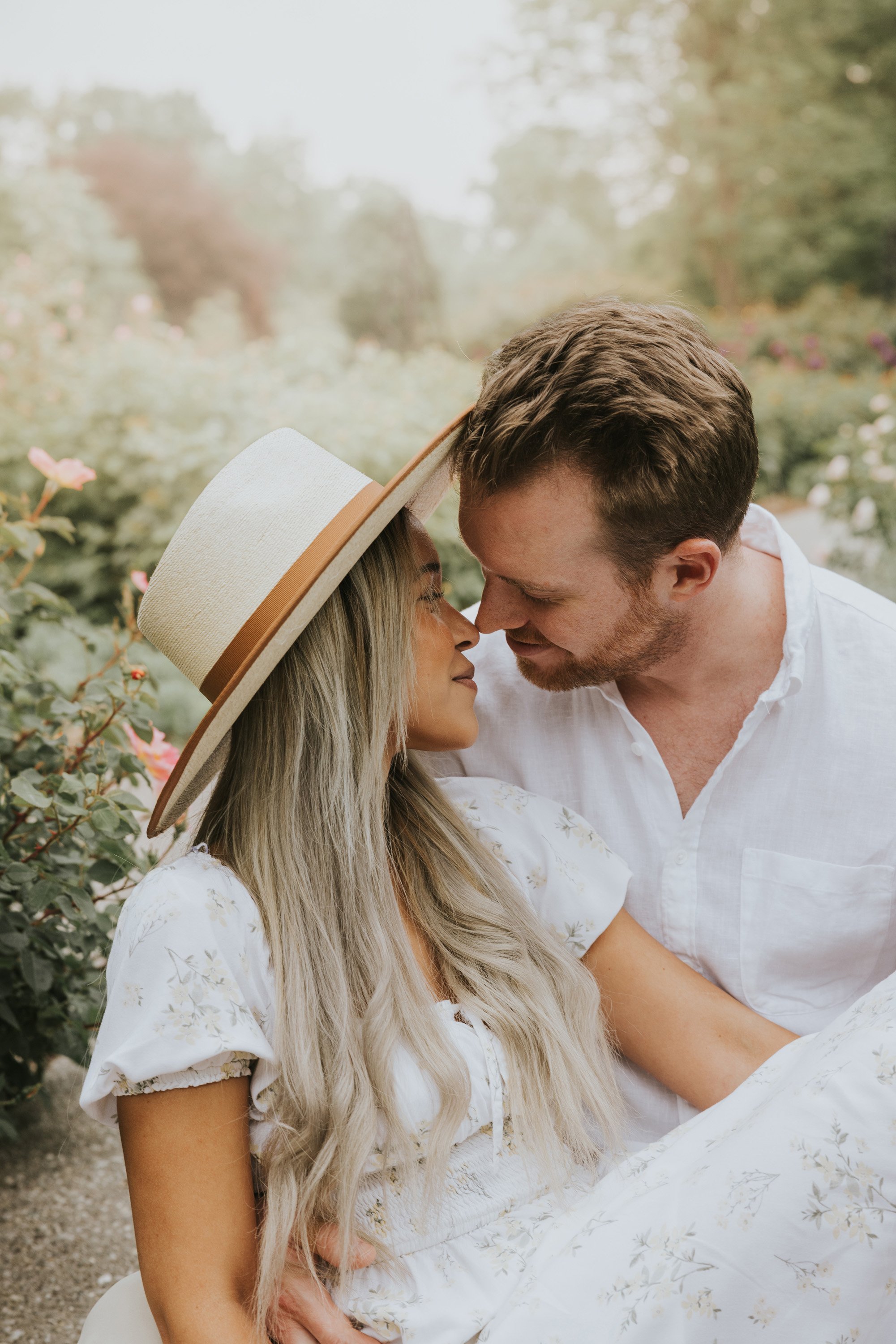 A close-up shot of a couple gazing lovingly into each other's eyes in a lush garden, their connection evident in the intimate moment captured.