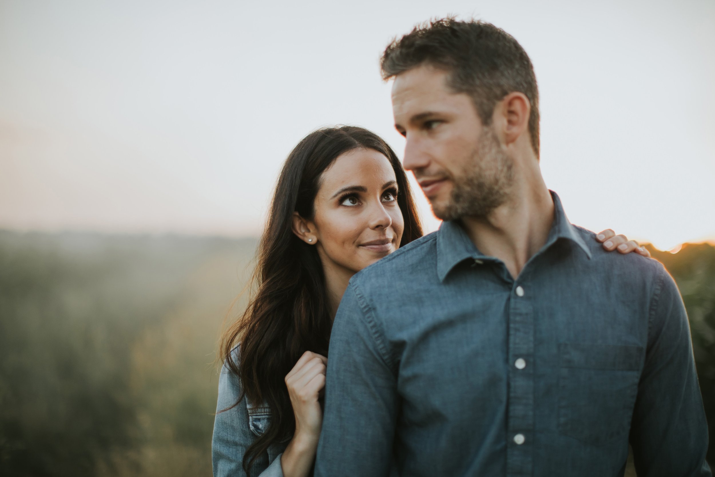 A couple sharing a loving stare during an engagement session, captured in a soft, intimate moment.
