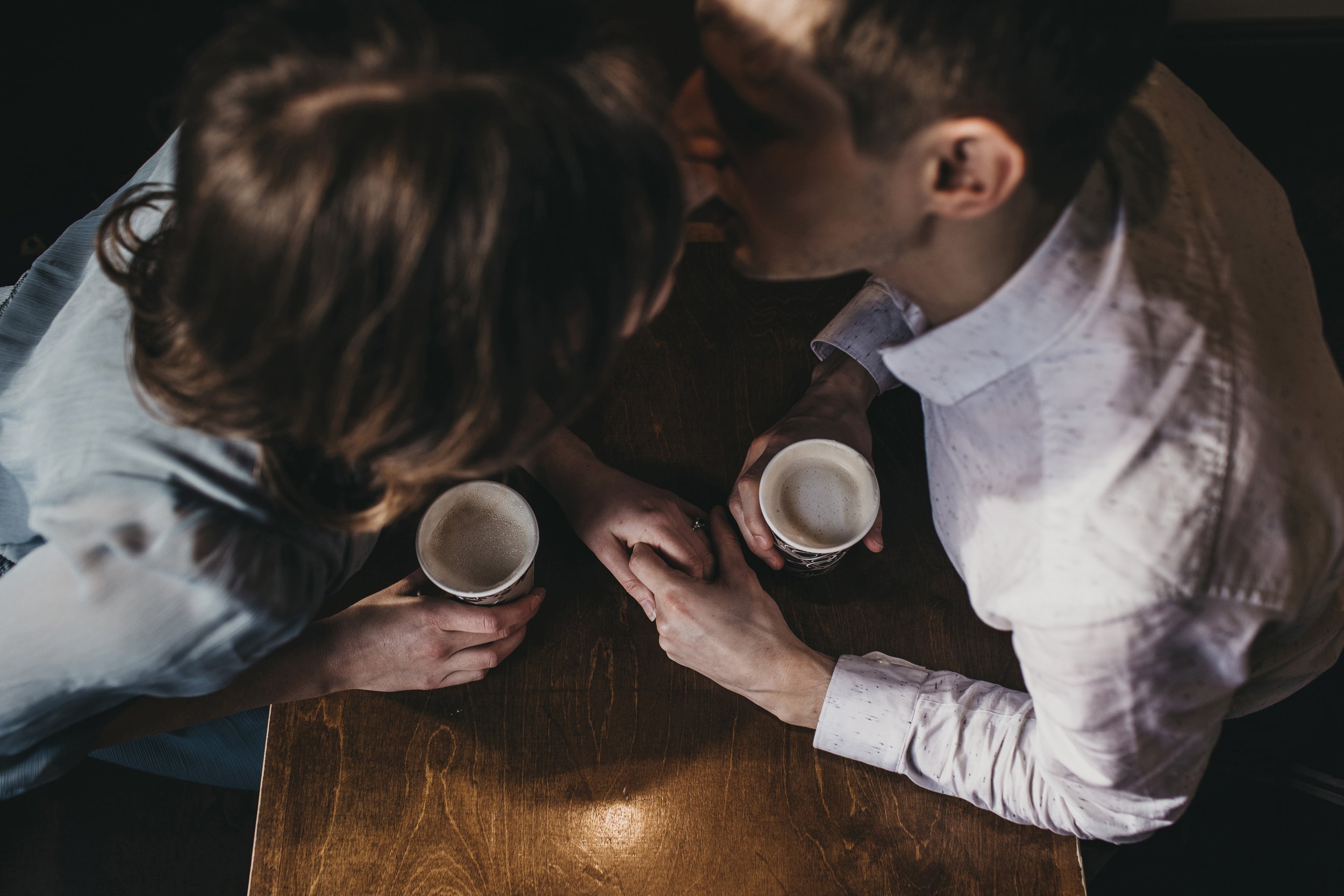 An overhead shot of a couple enjoying a cozy coffee date during their engagement session in London, Ontario.