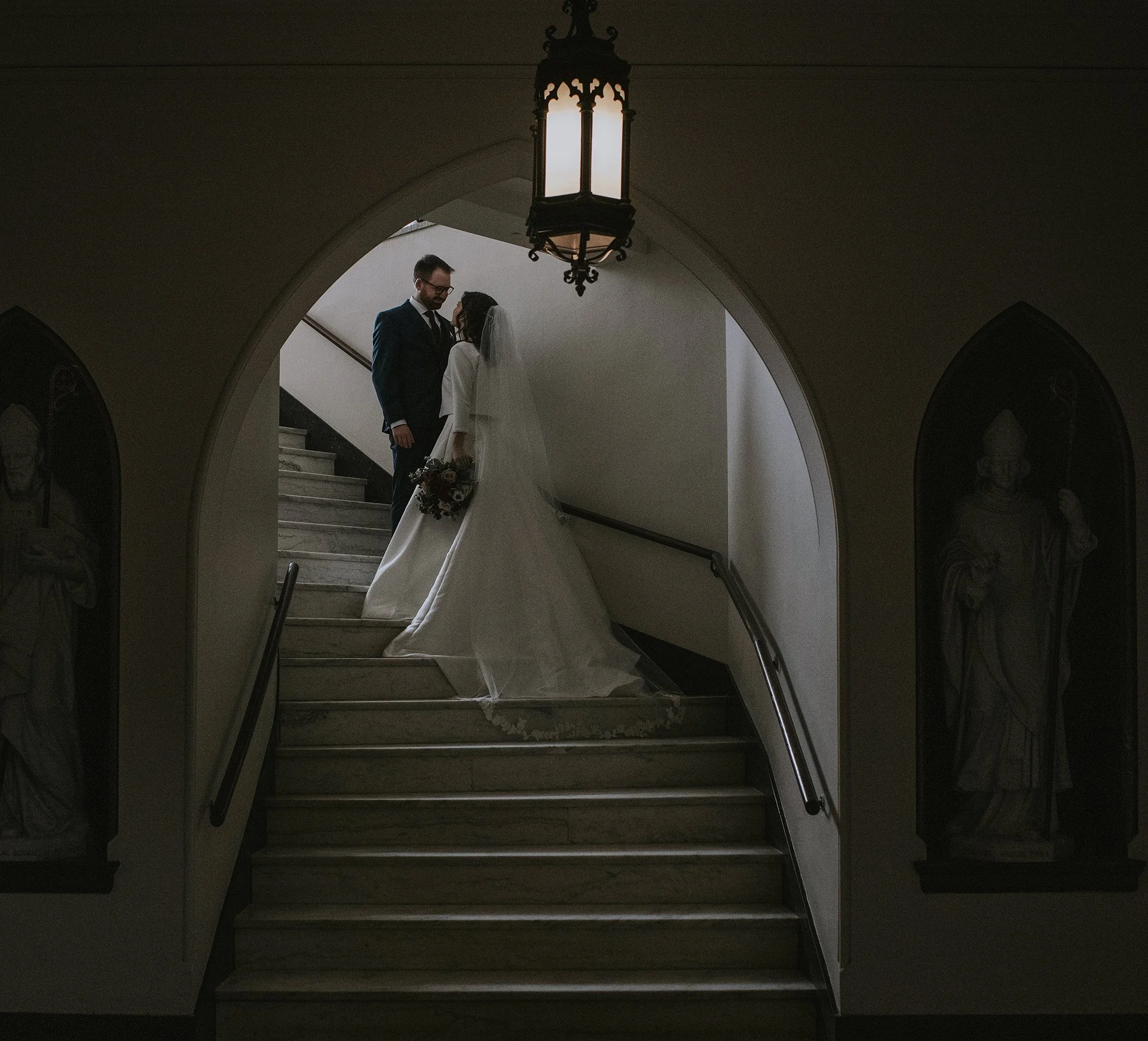 Groom-Bride-Loving-Embrase-Staircase-Arched-Hallway.jpg