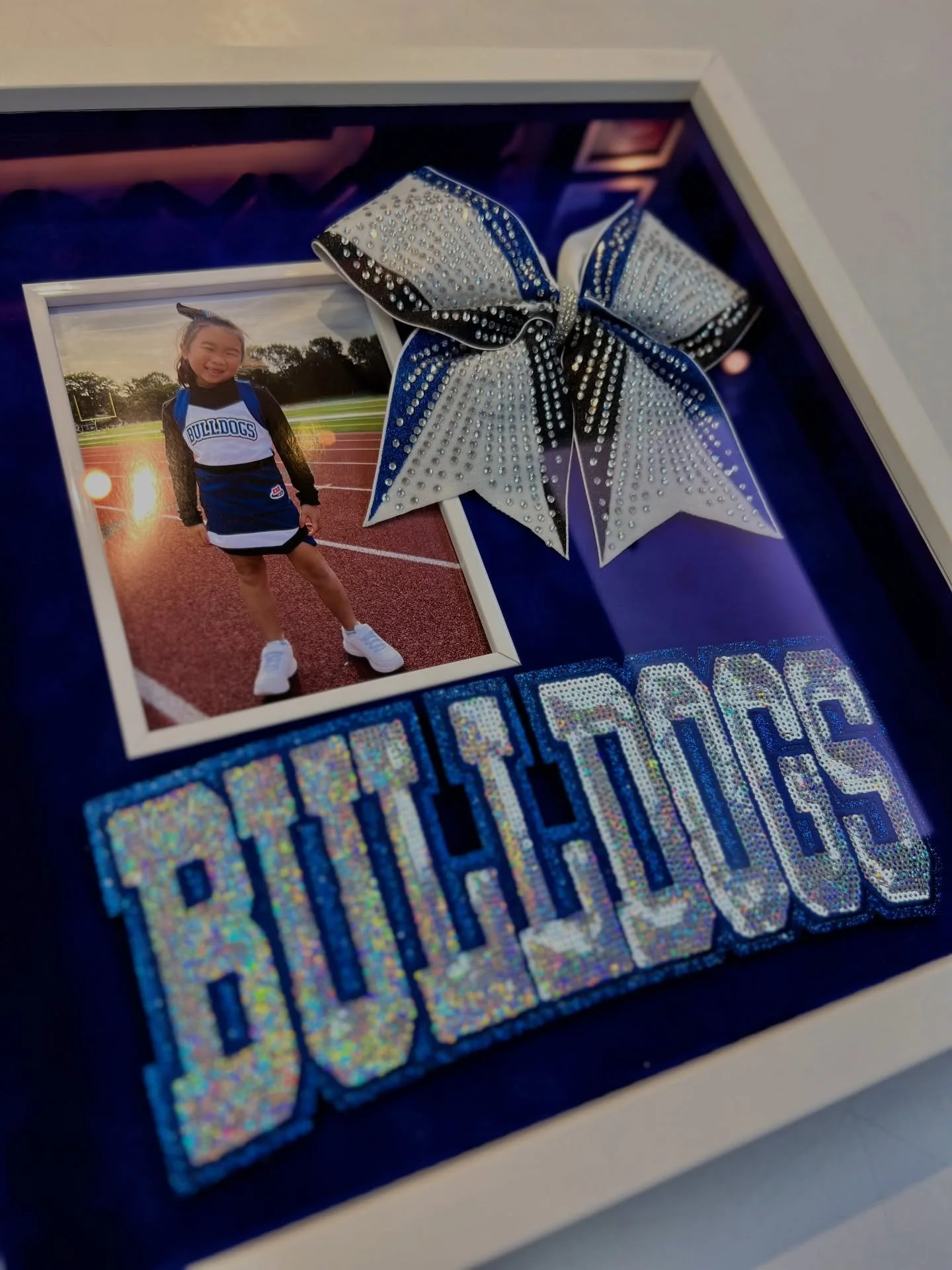 Celebrate their milestones! Framing children&rsquo;s achievements and keepsakes is a gift every proud parent will love. 💙📸
.
.
.
#giftideas #cheer #cheergifts #gifts #bulldogs #metuchennj #edisonnj #myframingstore #njsmallbusiness #customframing