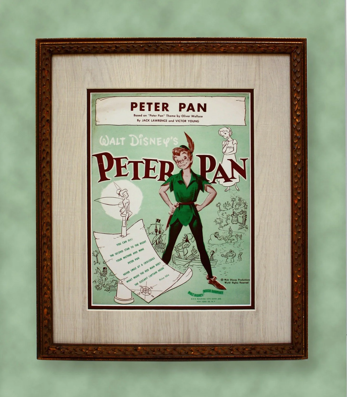 Peter Pan sheet music book, framed with a unique wood texture matting. Stop by and we will help you choose the best design for your artwork.