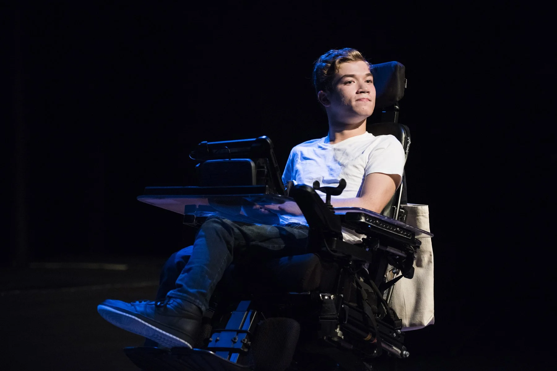 Thomas performs on stage in his power wheelchair.