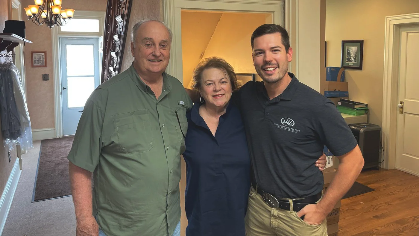 Whitetail Properties Iowa Land Specialist Ben Harshyne with seller clients at a land closing.