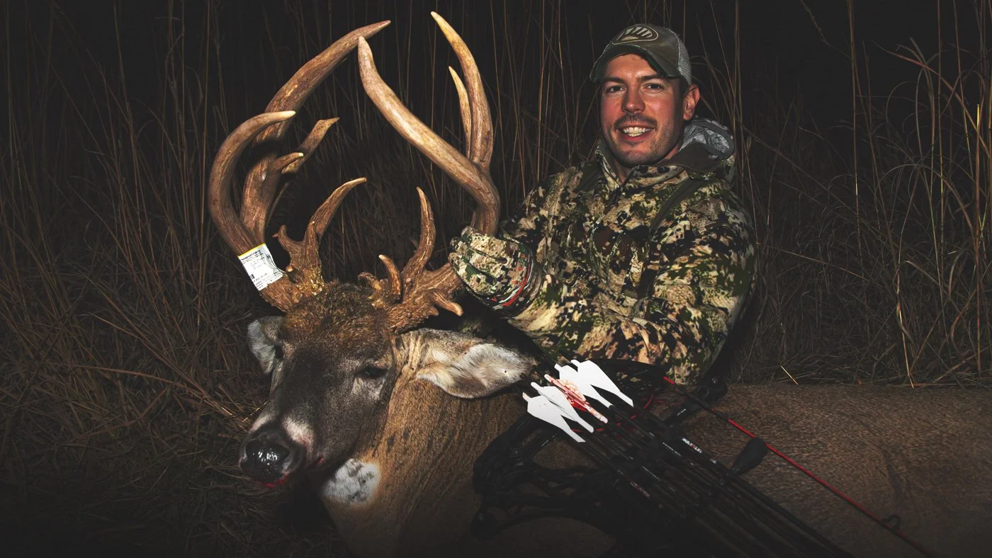 Ben Harshyne, an Iowa Land Specialist with Whitetail Properties Real Estate in Iowa with a trophy whitetail buck that he took with a bow