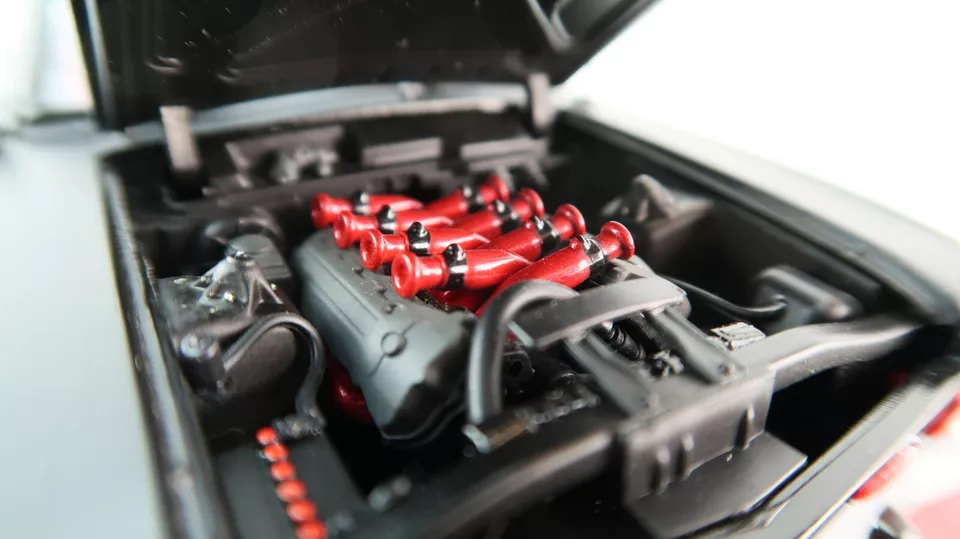 Limited-edition 1:24 scale DDA Ford Falcon XW 1969 “Inferno” die-cast model – matte black, carbon-look bonnet, red headlights, window-box packaging.