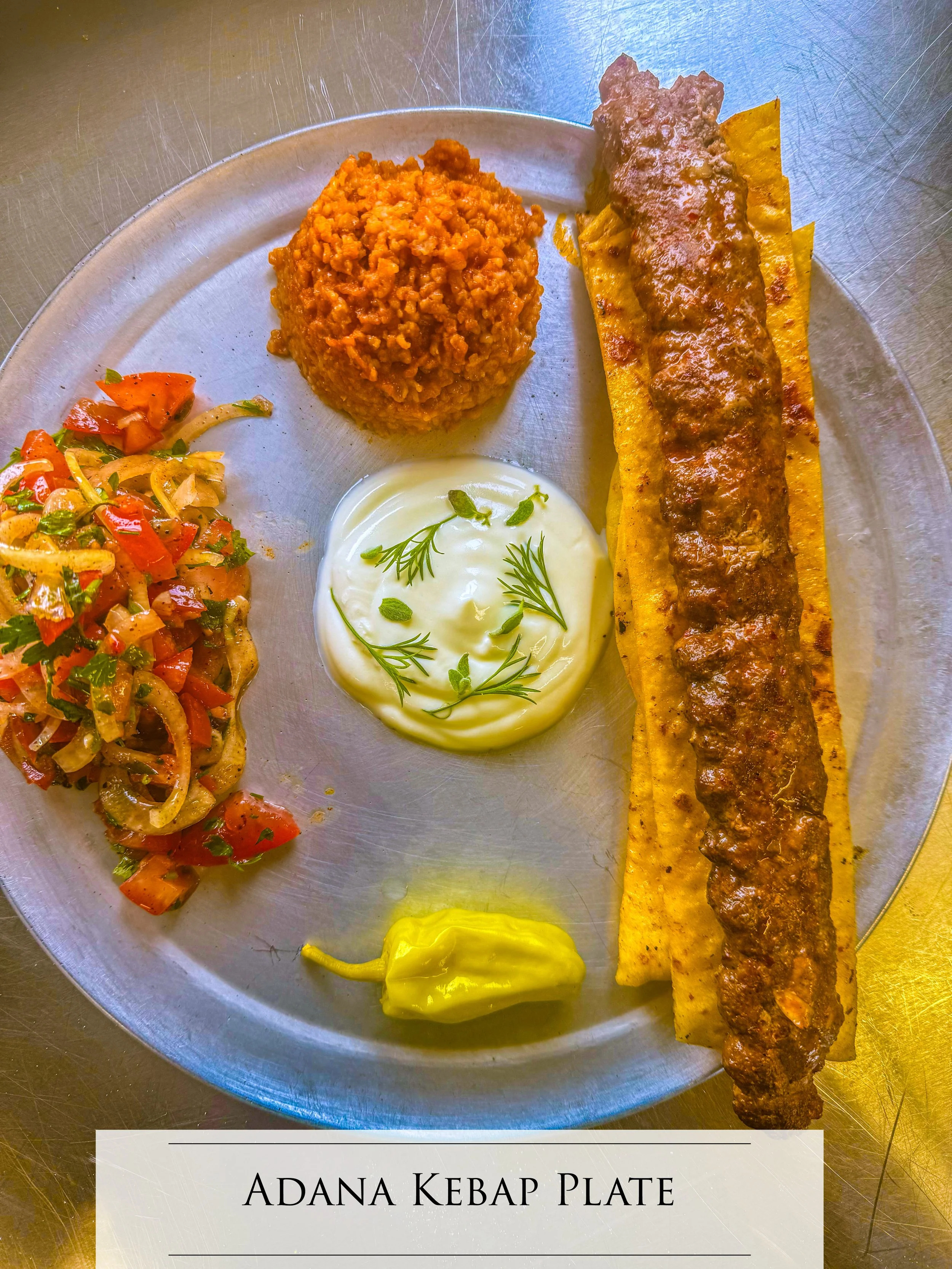 8 oz Adana, on the bed of sliced, lavas jbread with pepper spread