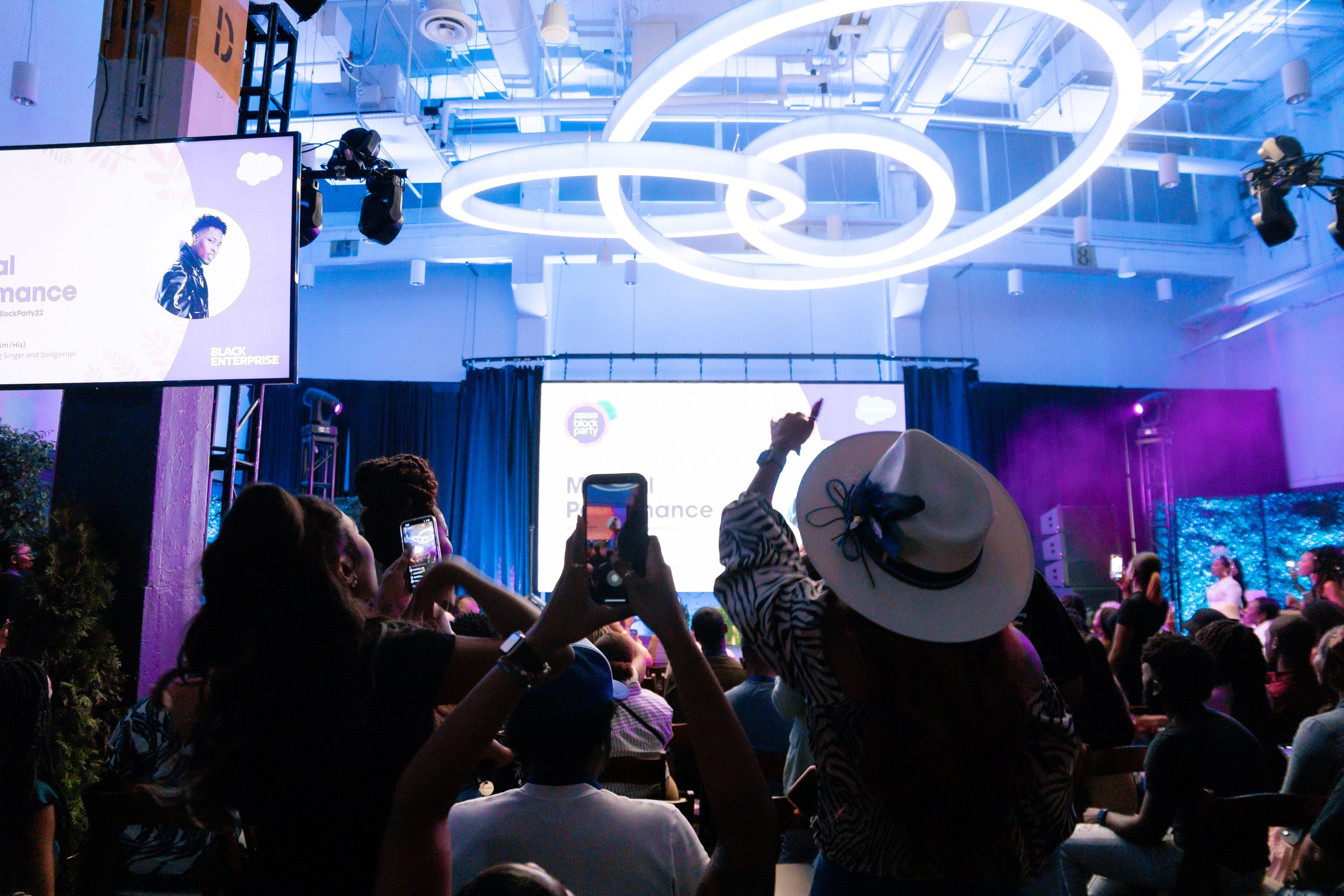 silhouette of a crowd facing the stage with the hands and phones up in the air in celebration at an event in Atlanta, Georgia