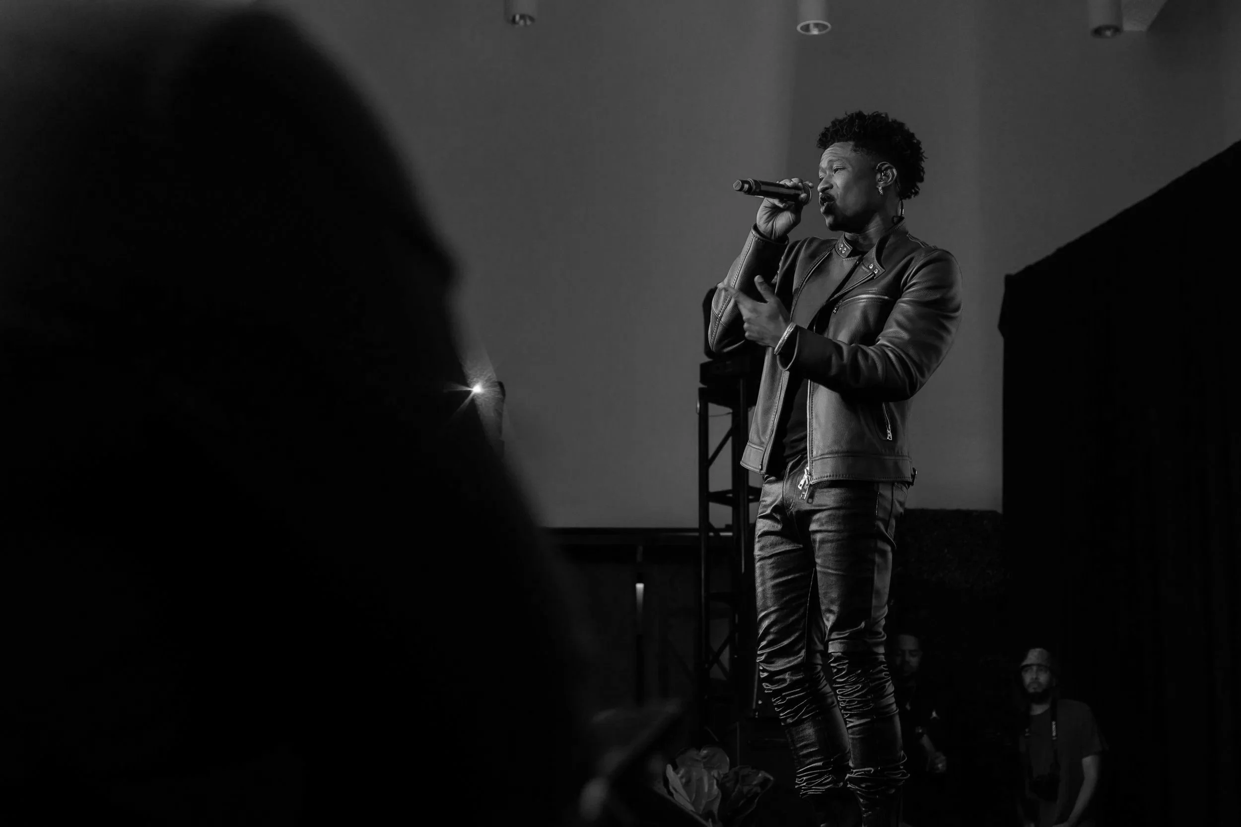 LUCKY DAYE HOLDING MICROPHONE TO MOUTH SINGING SONG ON STAGE
