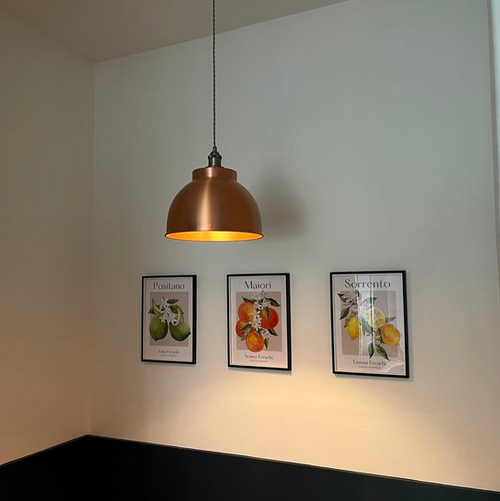Three framed pictures mounted perfectly level and evenly spaced on a bright kitchen wall by So Handyman Edinburgh.