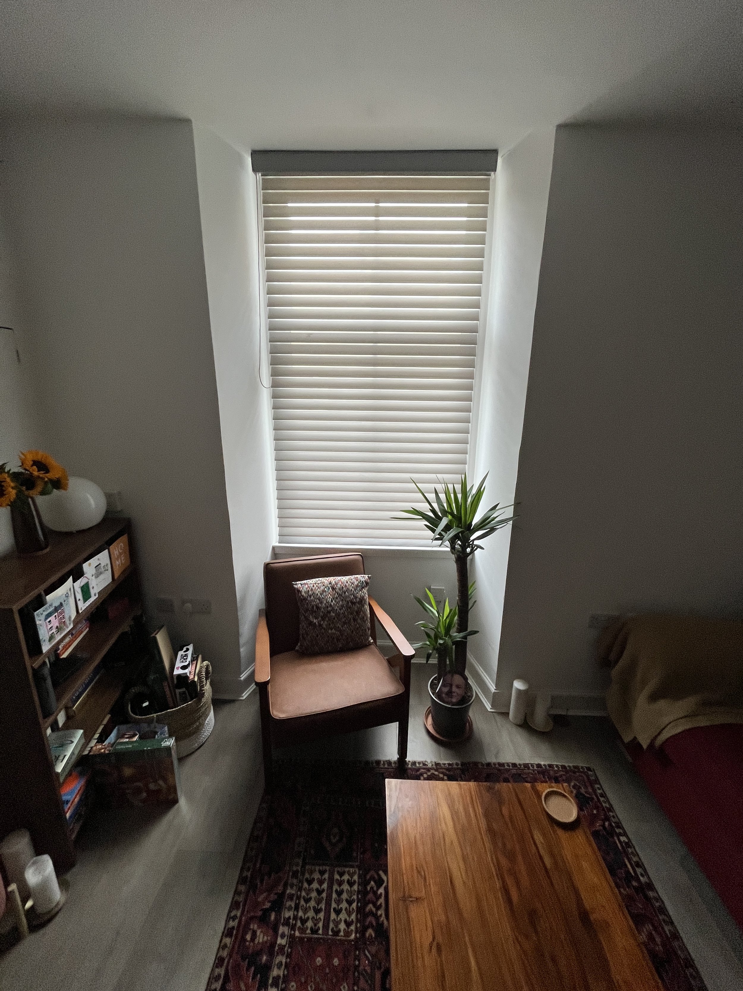 Frank from So Handyman Edinburgh installing electric remote-controlled window blinds in a high-ceiling tenement window.