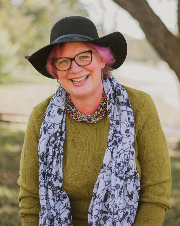Michelle Spalding, clinical herbalist and holistic coach at Wild Thistle Herbs and Alchemy, smiling outdoors.