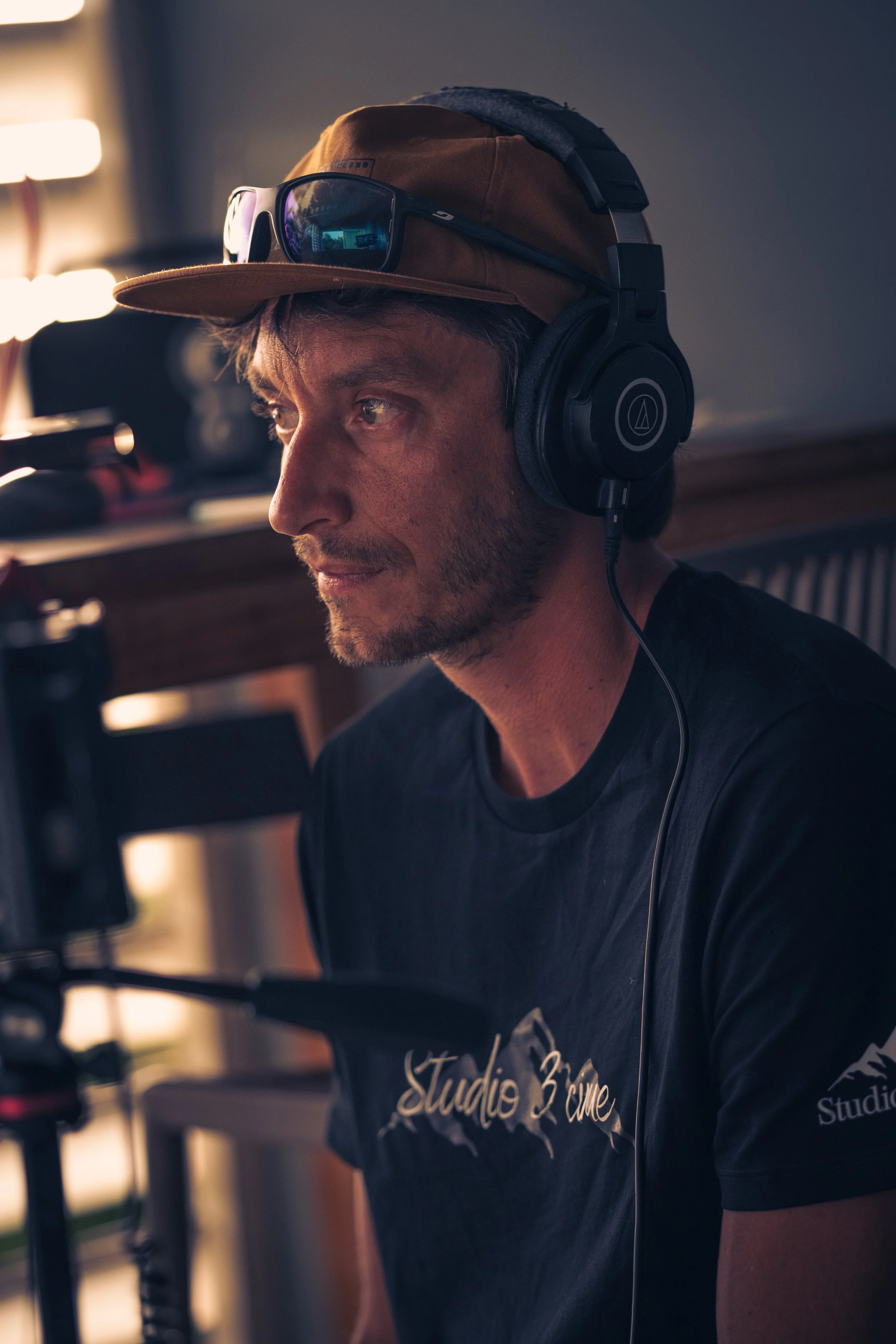 Filmmaker wearing Studio 3 Cime black t-shirt sitting in front of a camera