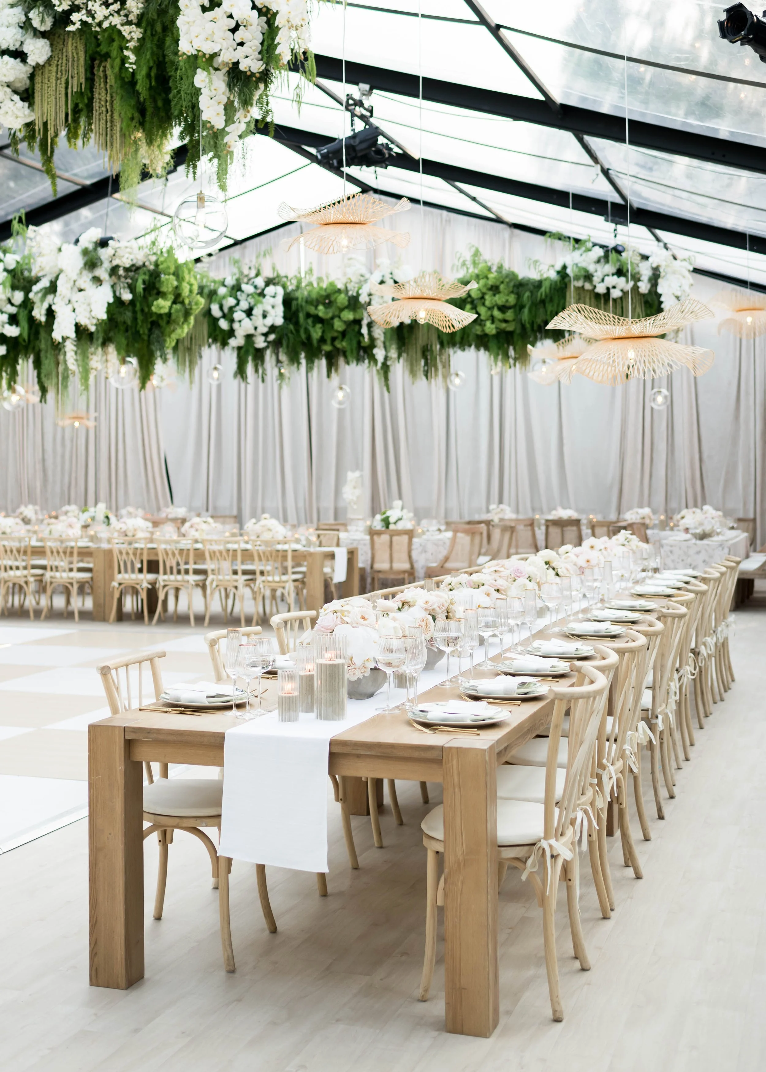 Tented wedding reception with hanging floral installations