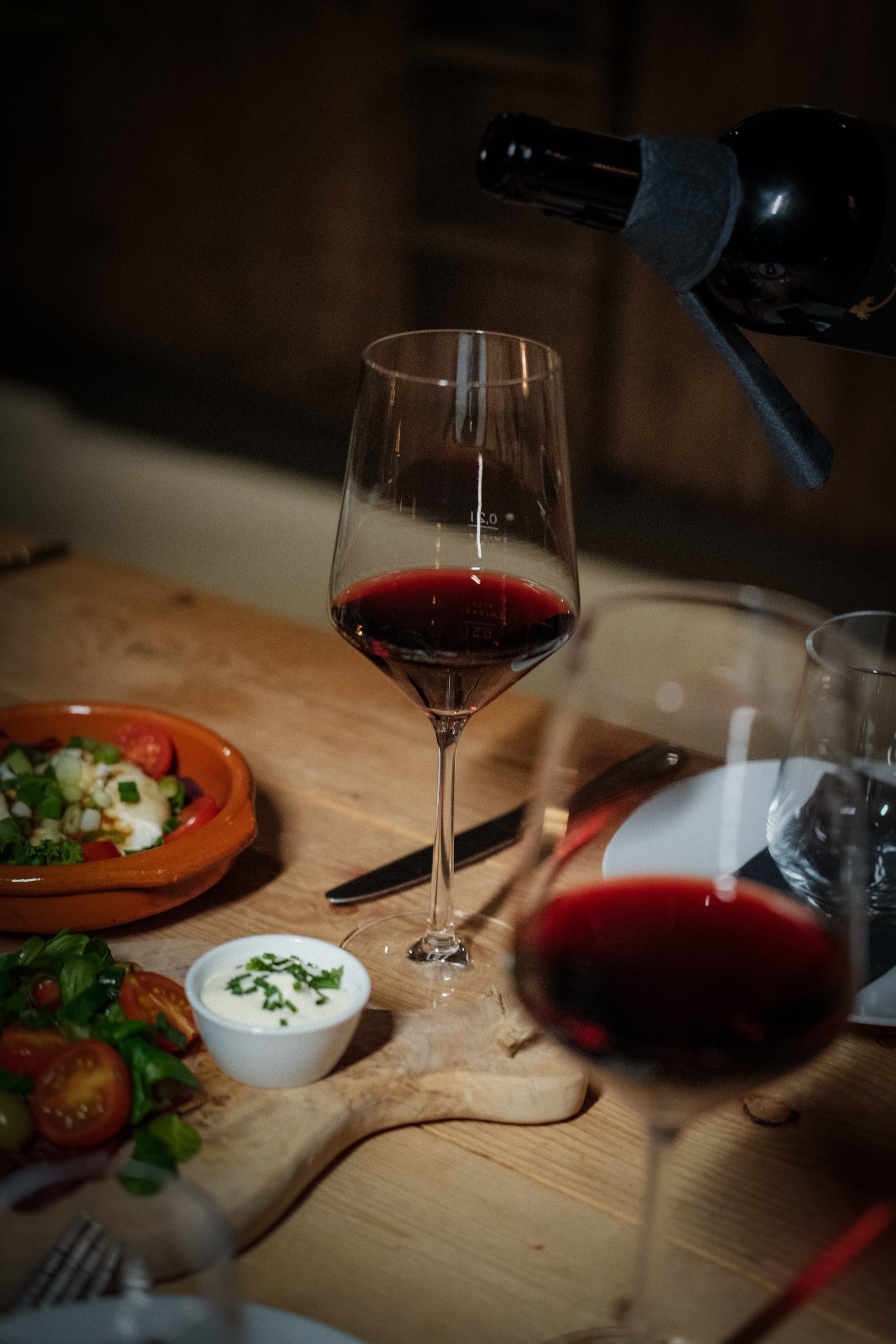 Wine pouring into a glass, photographed to showcase motion and elegance