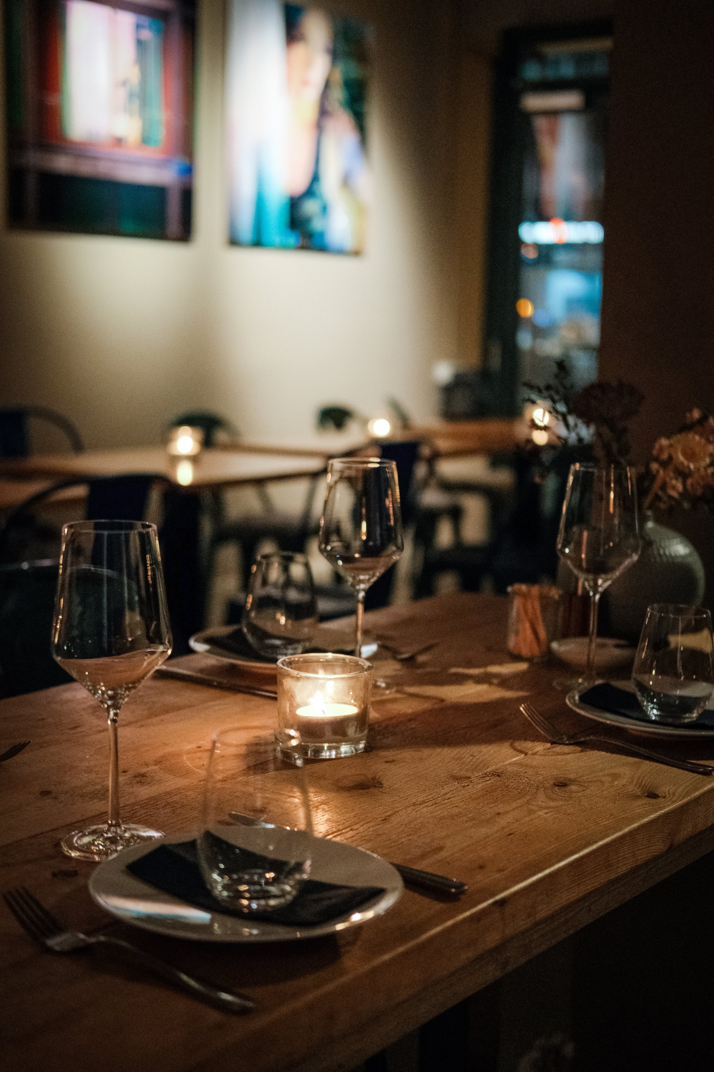 Elegant table setting with candles and wine glasses during a professional photoshoot