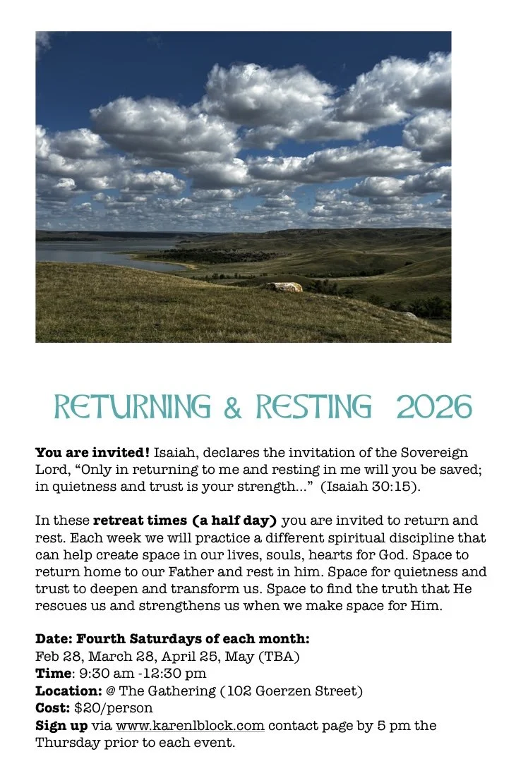 Landscape view of rolling green hills, a body of water, and a sky filled with large, fluffy clouds.