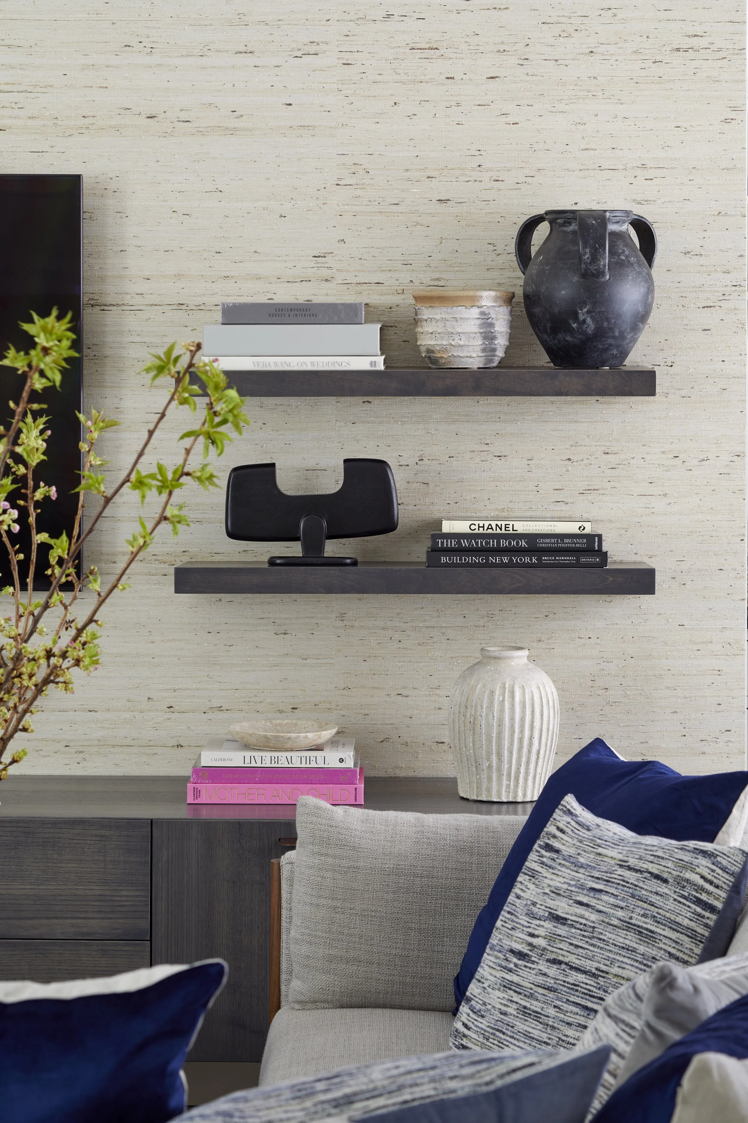 Decorative shelves with books and vases in a modern living room.