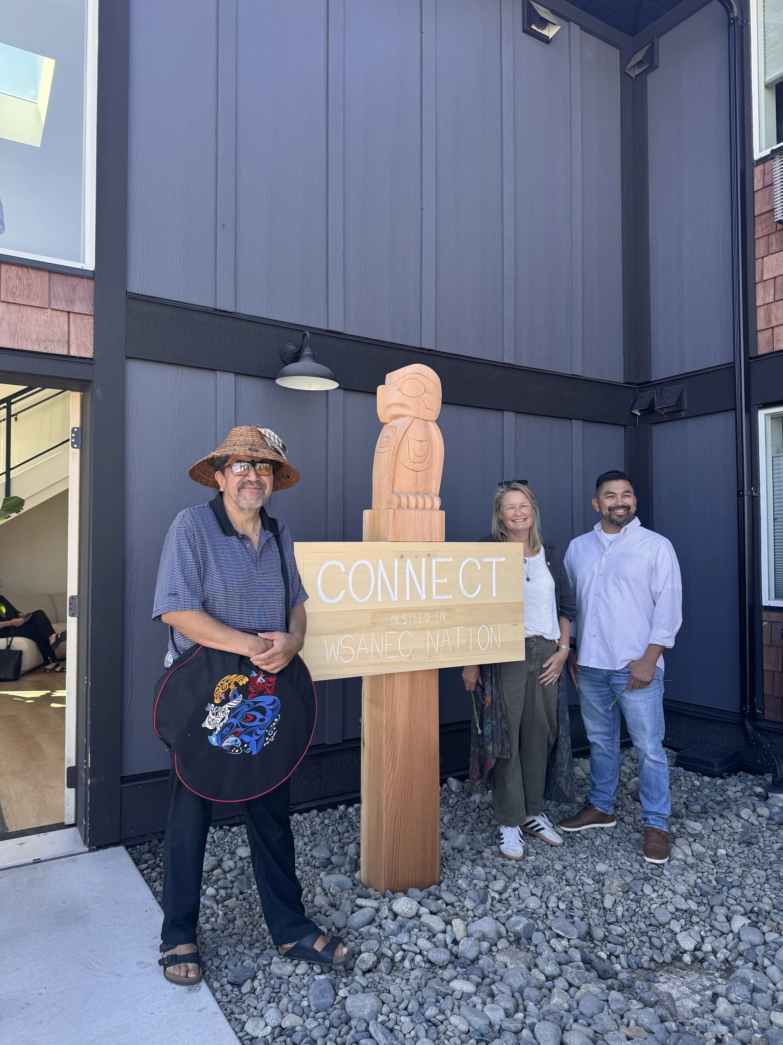 A carved sign by Indigenous artist Bear Horne decorates the entrance of CONNECT Saanich Peninsula