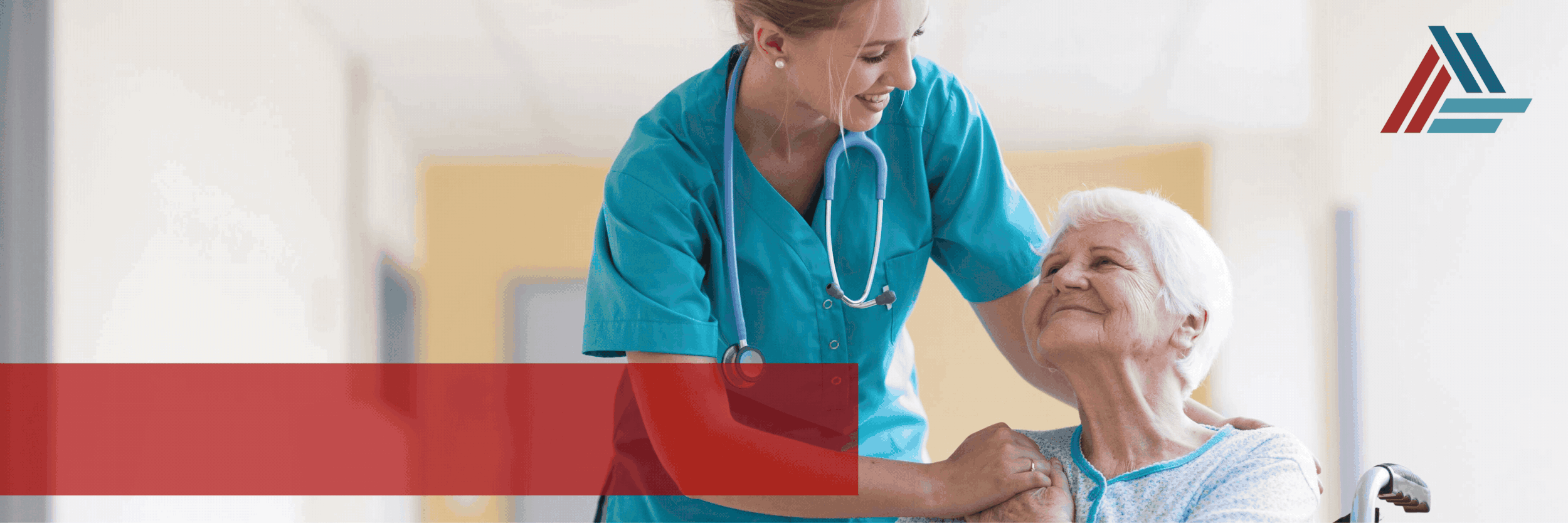 A nurse smiling and with a stethoscope around her neck caring for an elderly woman in a hospital or healthcare setting.
