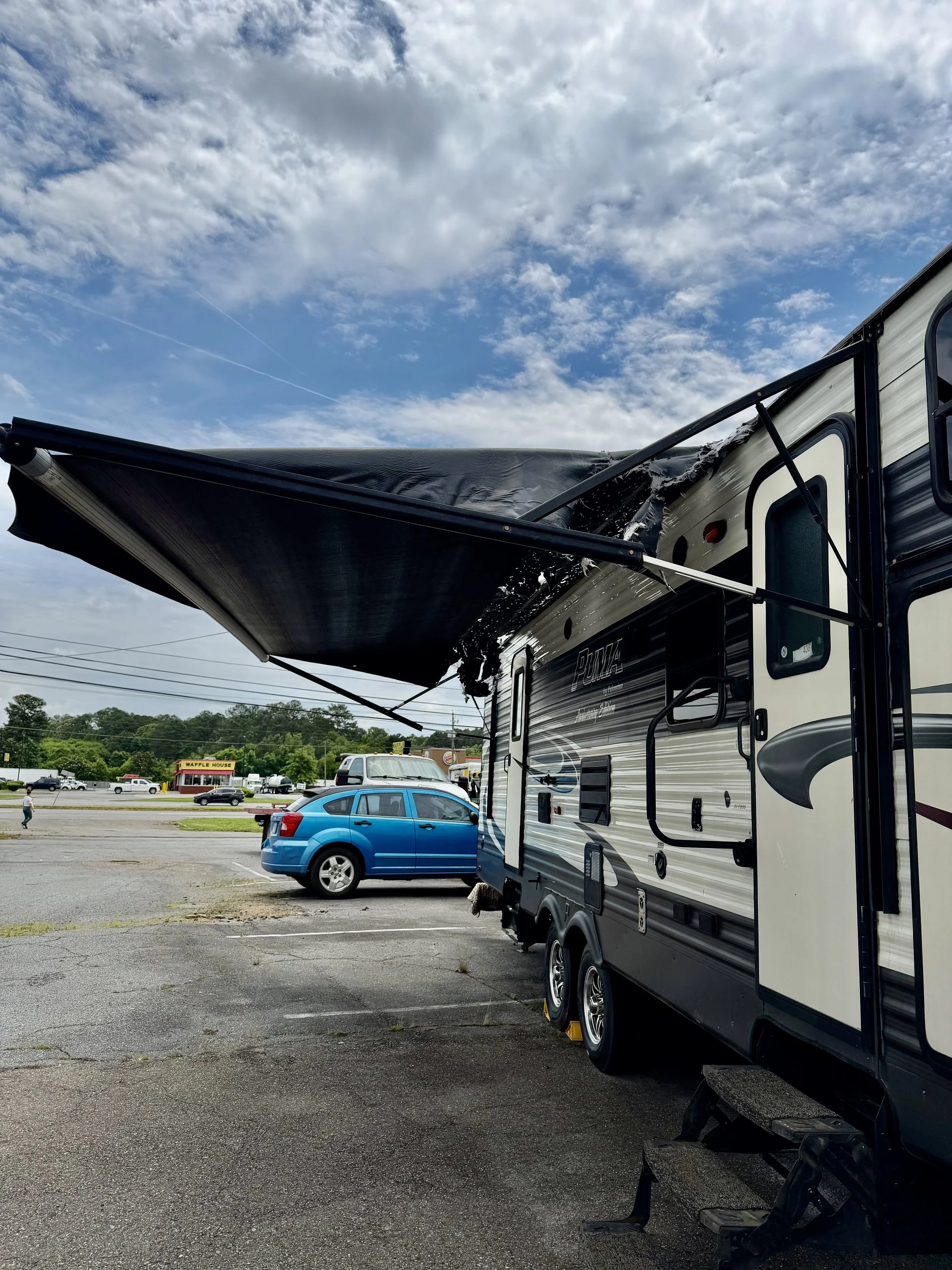 torn RV awning fabric in need of repair. RV Awning fabric replaced by Total RV Solutions.
