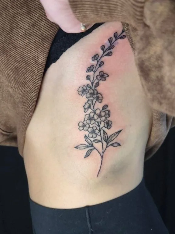 delicate-floral-forget-me-not-flowers-rib-tattoo.jpg