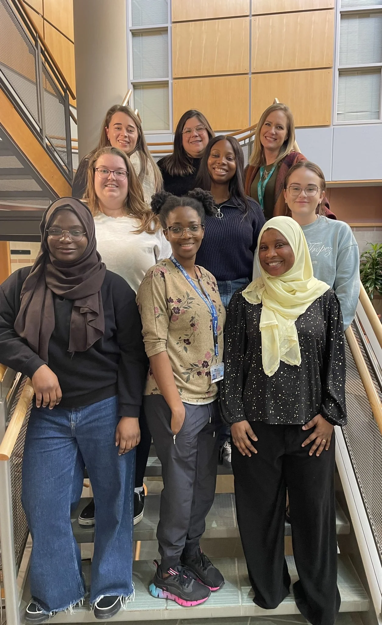 Group photo in the Helen Glass Atrium — Left to right: Sharifat Makinde, Michaela Bourque, Stephanie Mazzon, Gifty Dzorka, Aniela Mora Menendez, Oluwatoyosi Fagbuyi, Omolara Akinwale, Dr. Mandy Archibald, Madissen Sitka