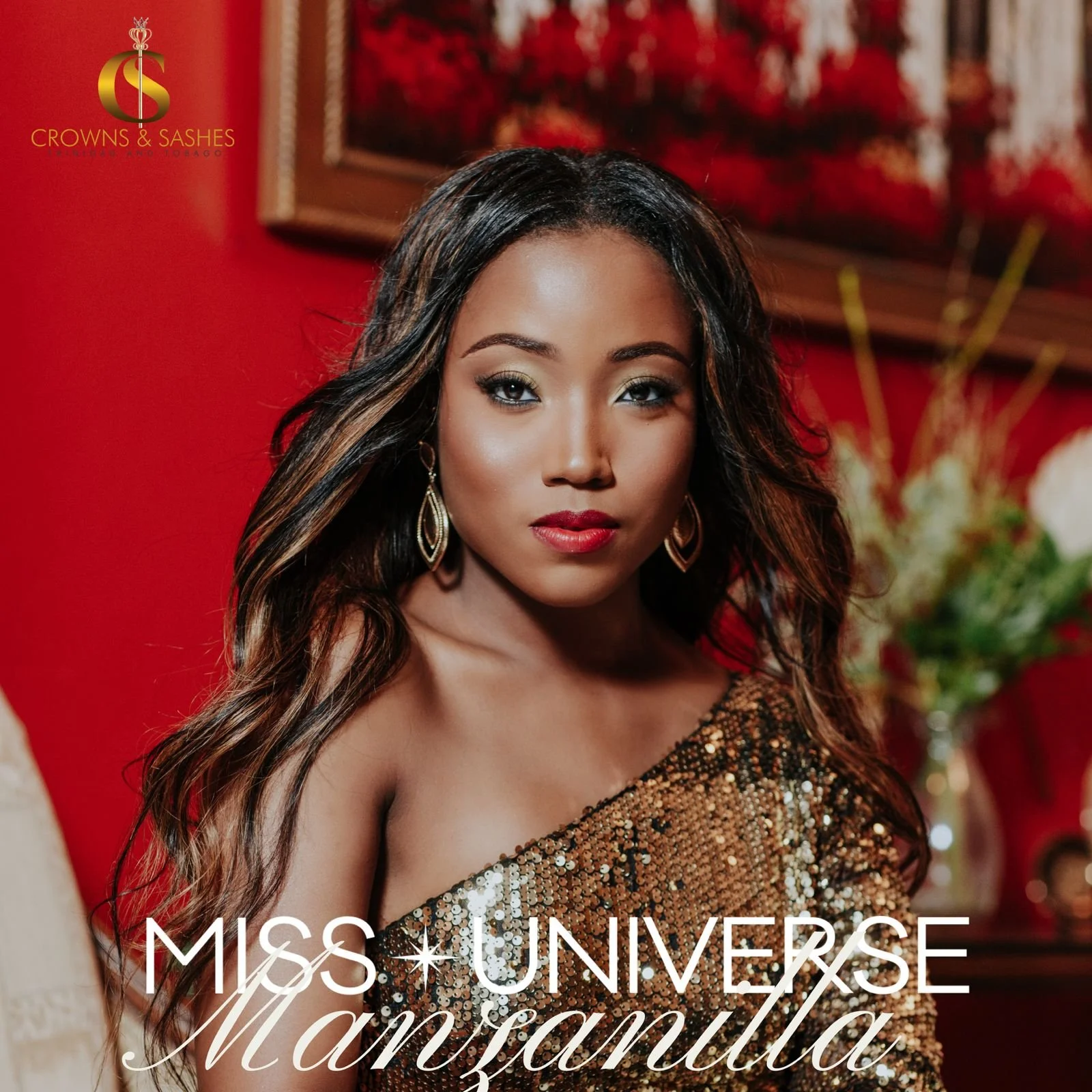 Miss Universe Manzanilla with long wavy hair, wearing gold earrings and a one-shoulder sequined dress, in front of a red background with floral arrangements and artwork.