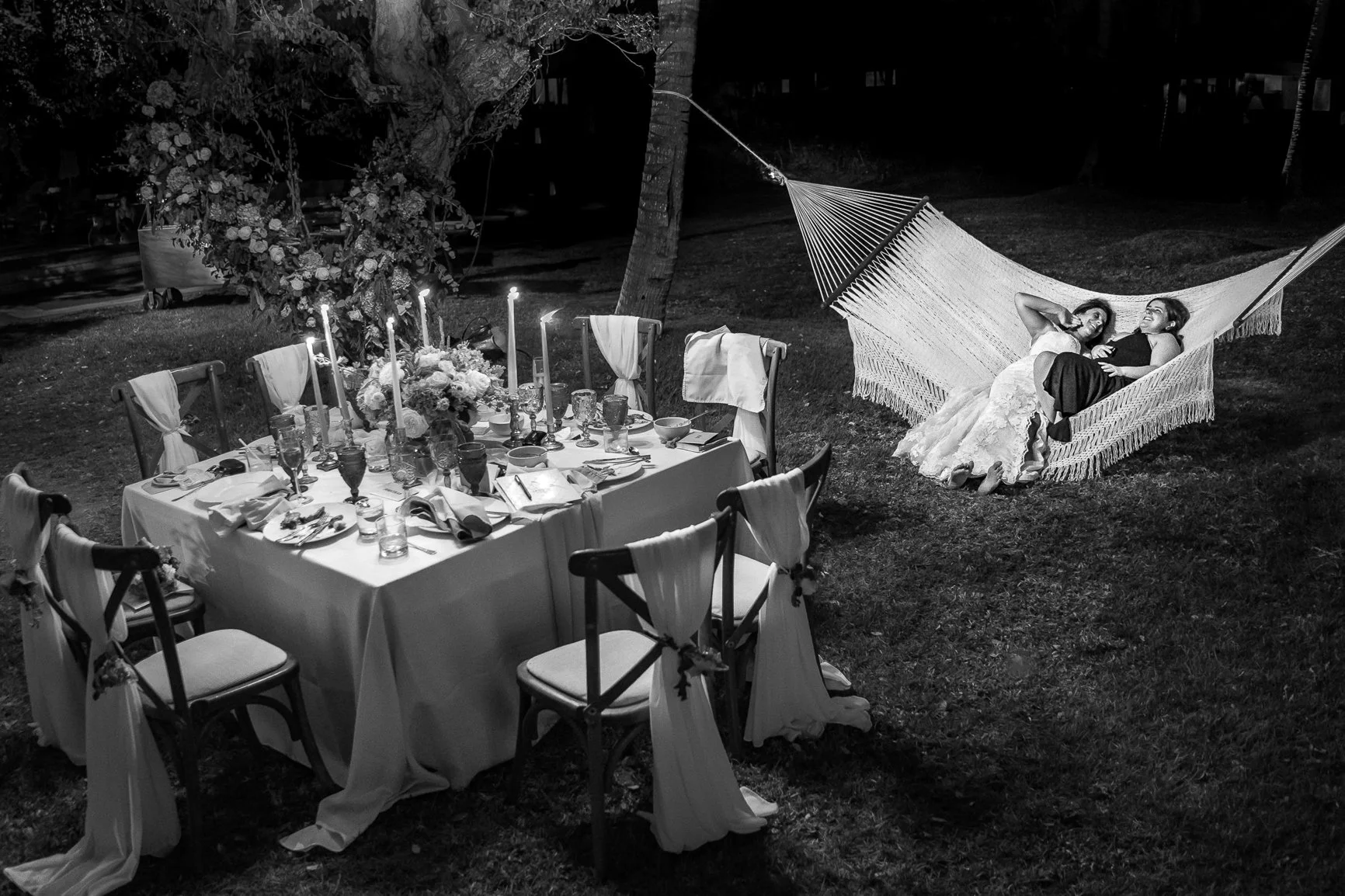 Bride with daughter relaxing after their elopement reception dinner at =the St. Regis Resort in Punta de Mita, Mexico.
