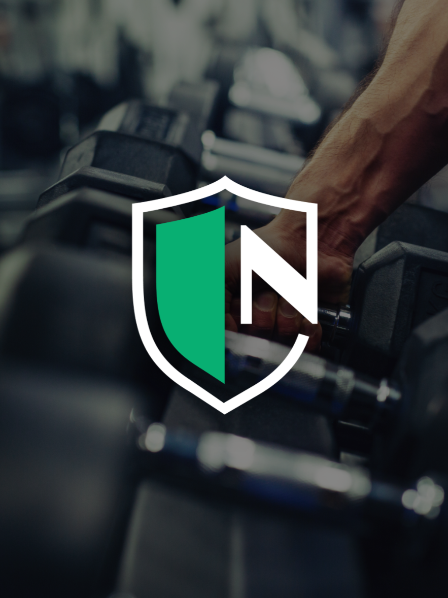 Close-up of a person's hand gripping a dumbbell in a gym with a shield logo overlay.