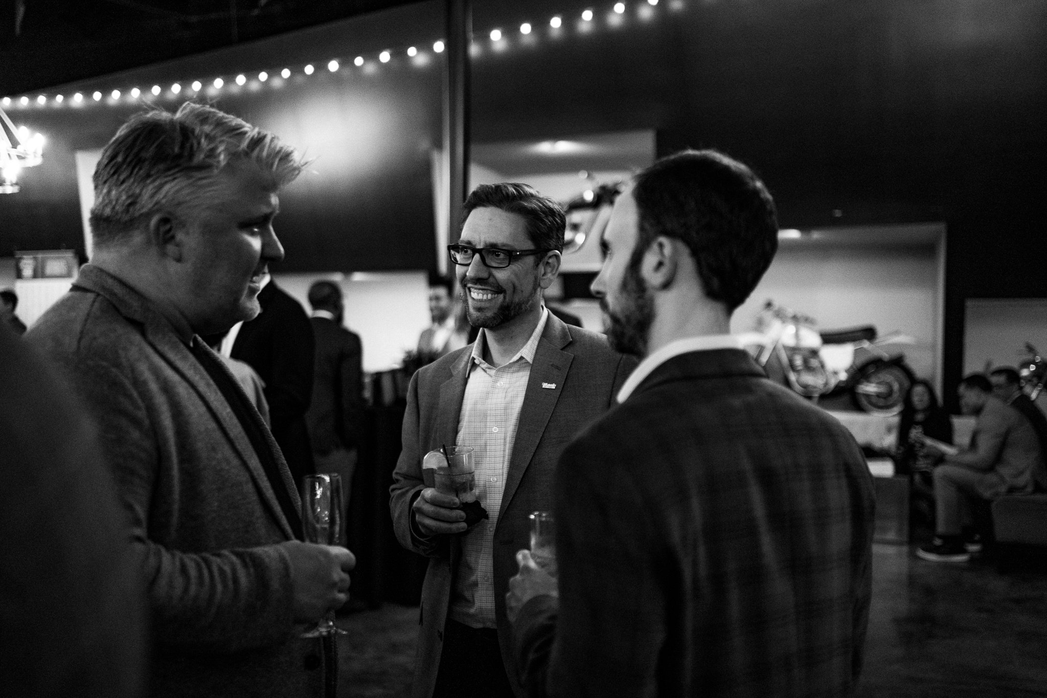 corporate event guests smiling and having a drink at moto museum event venue