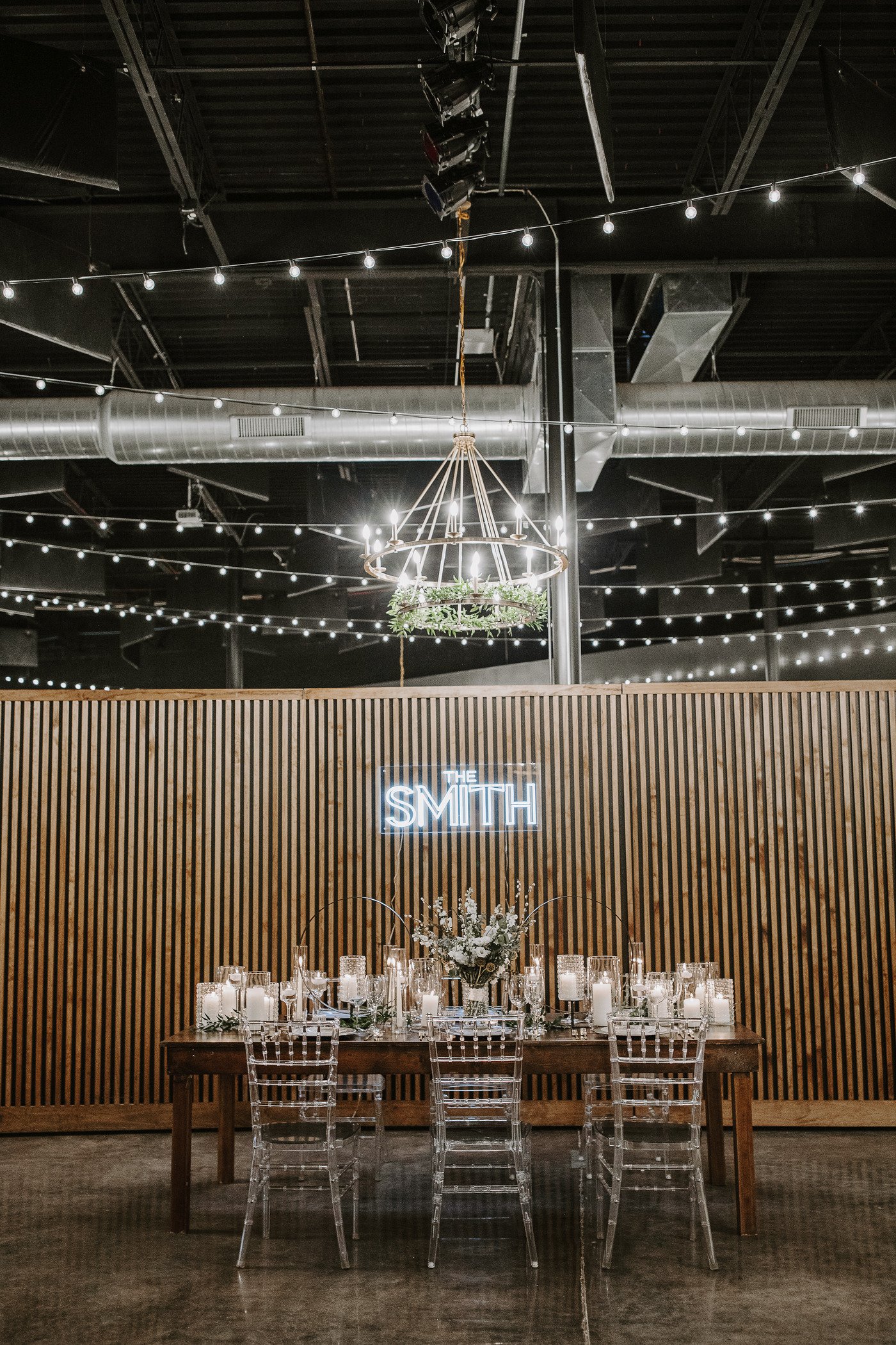 smith and co wedding table setting in front of moveable wood slat wall