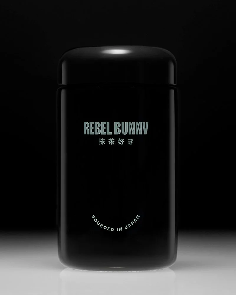 A black container with the text 'REBEL BUNNY' and Japanese characters, along with the phrase 'SOURCED IN JAPAN' on it.