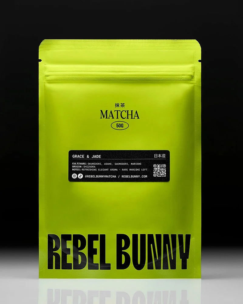 Bright green package of Rebel Bunny Matcha tea with black text, placed against a black background.