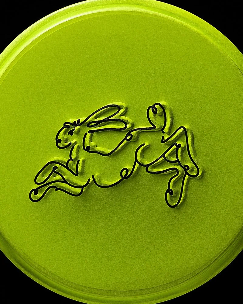Embossed rabbit on a green circular lid.