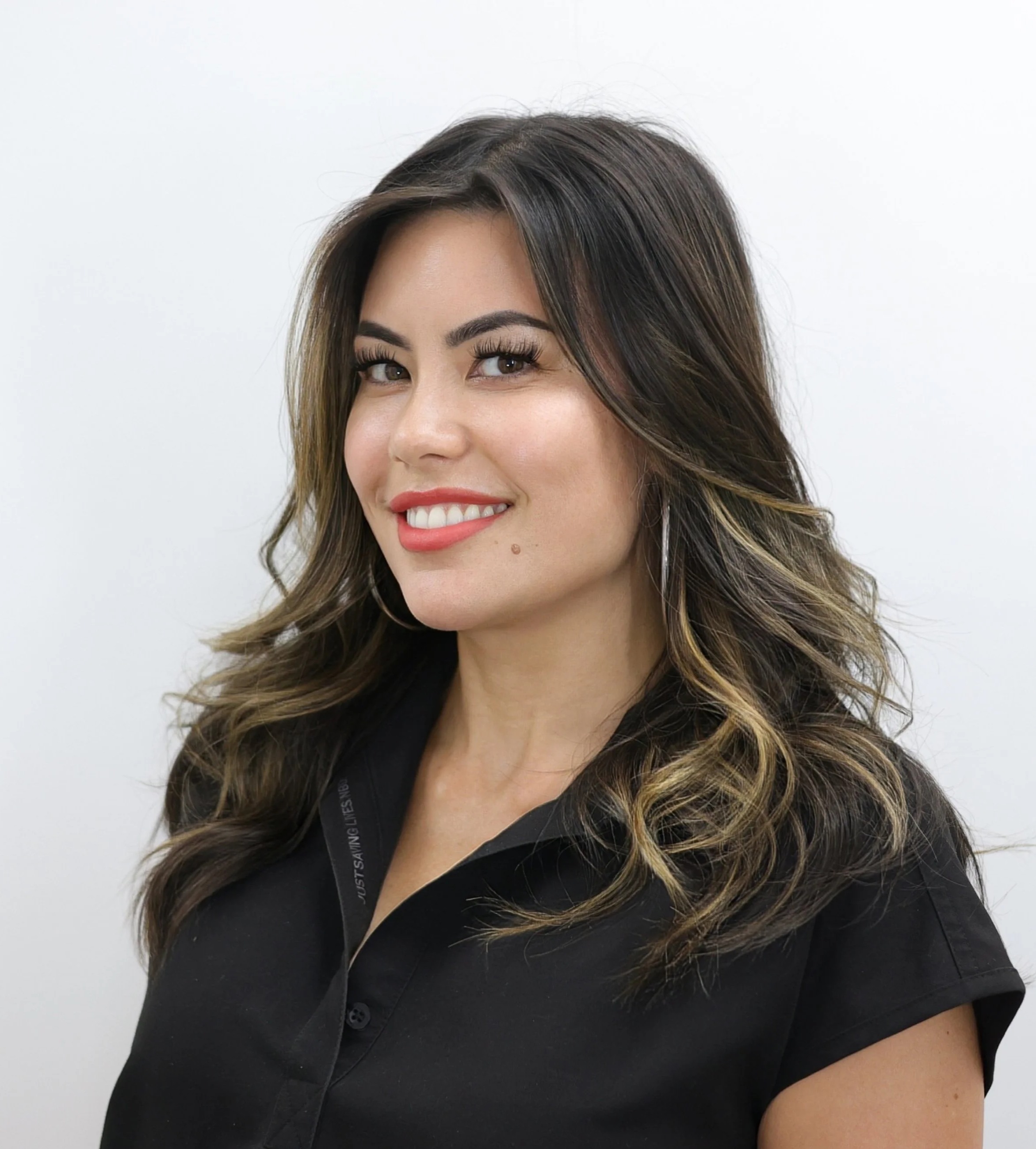 A professional headshot of a female aesthetician